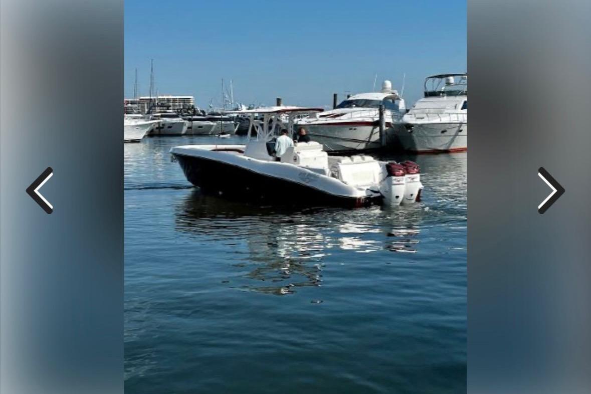 2015 Deep Impact 33 boat in marina, surrounded by yachts on a sunny day.