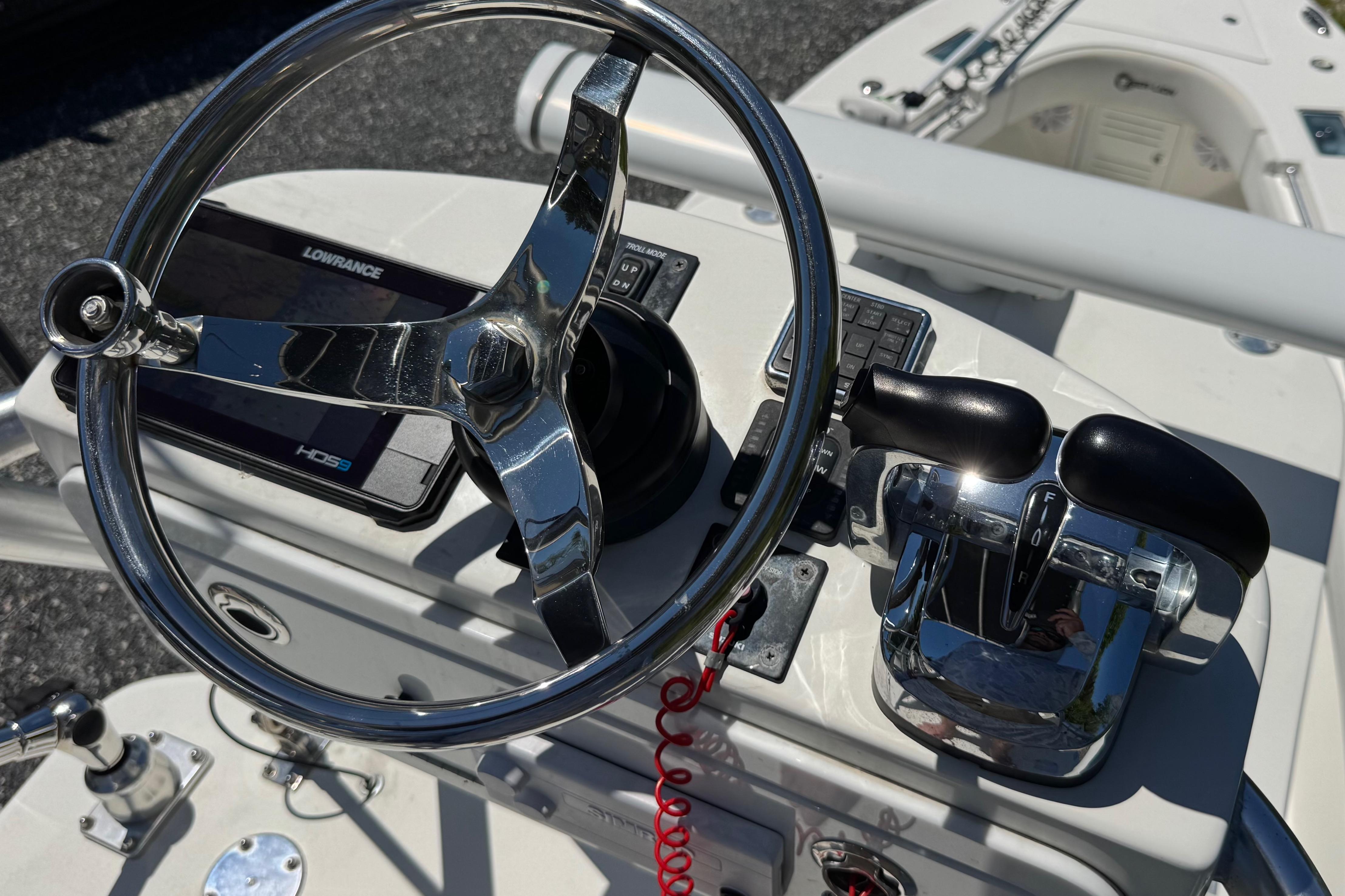 Steering console of 2020 Sea-Lion 34 TE boat with chrome wheel and controls.