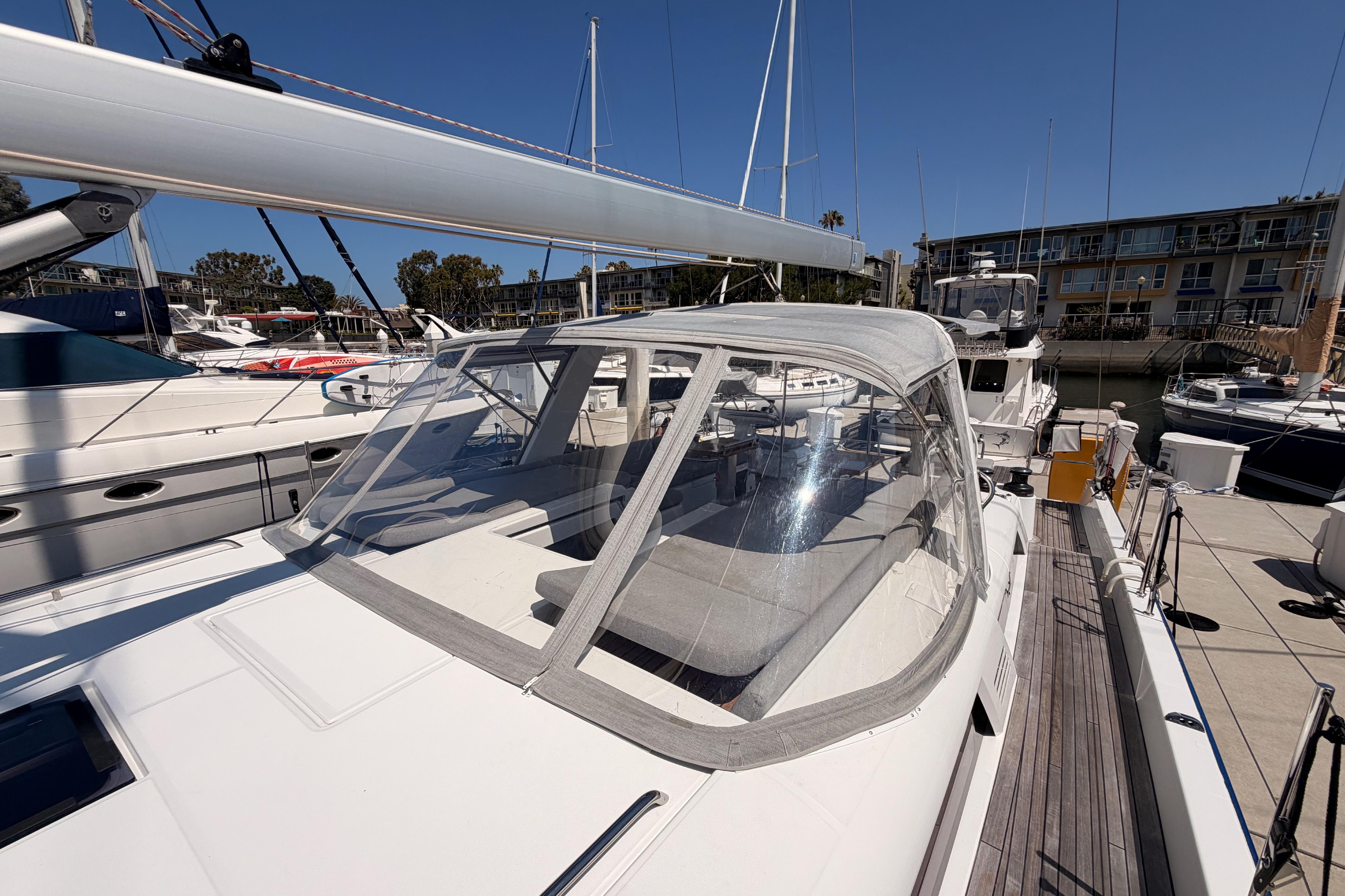 2022 Beneteau Oceanis Yacht 54 docked, showcasing sleek design and spacious cockpit.