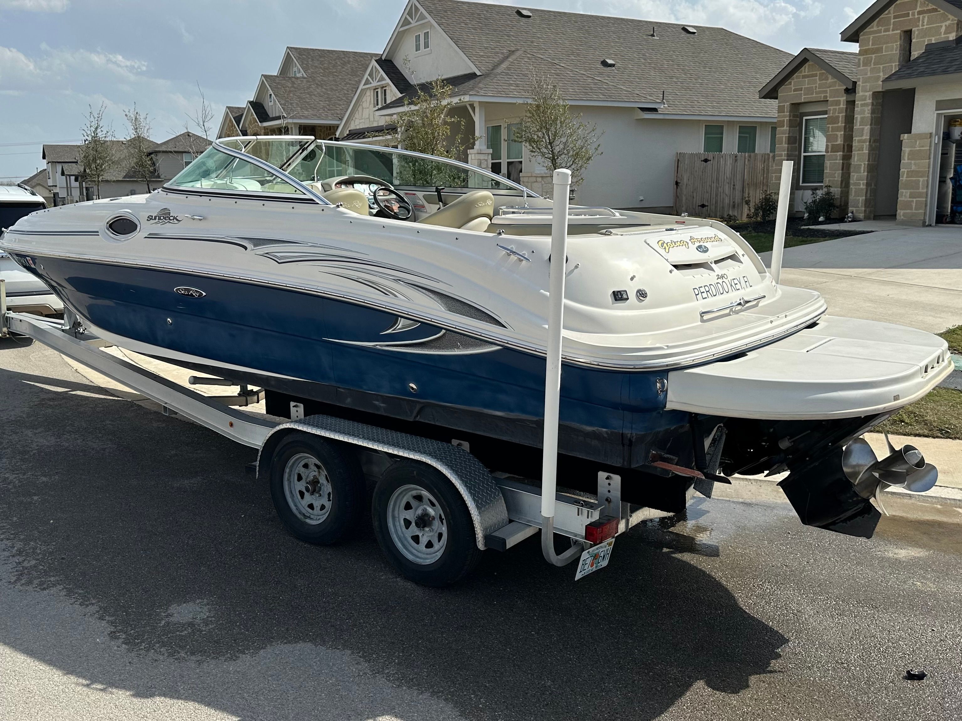 2006 Sea Ray 240 Sundeck on trailer in residential area.
