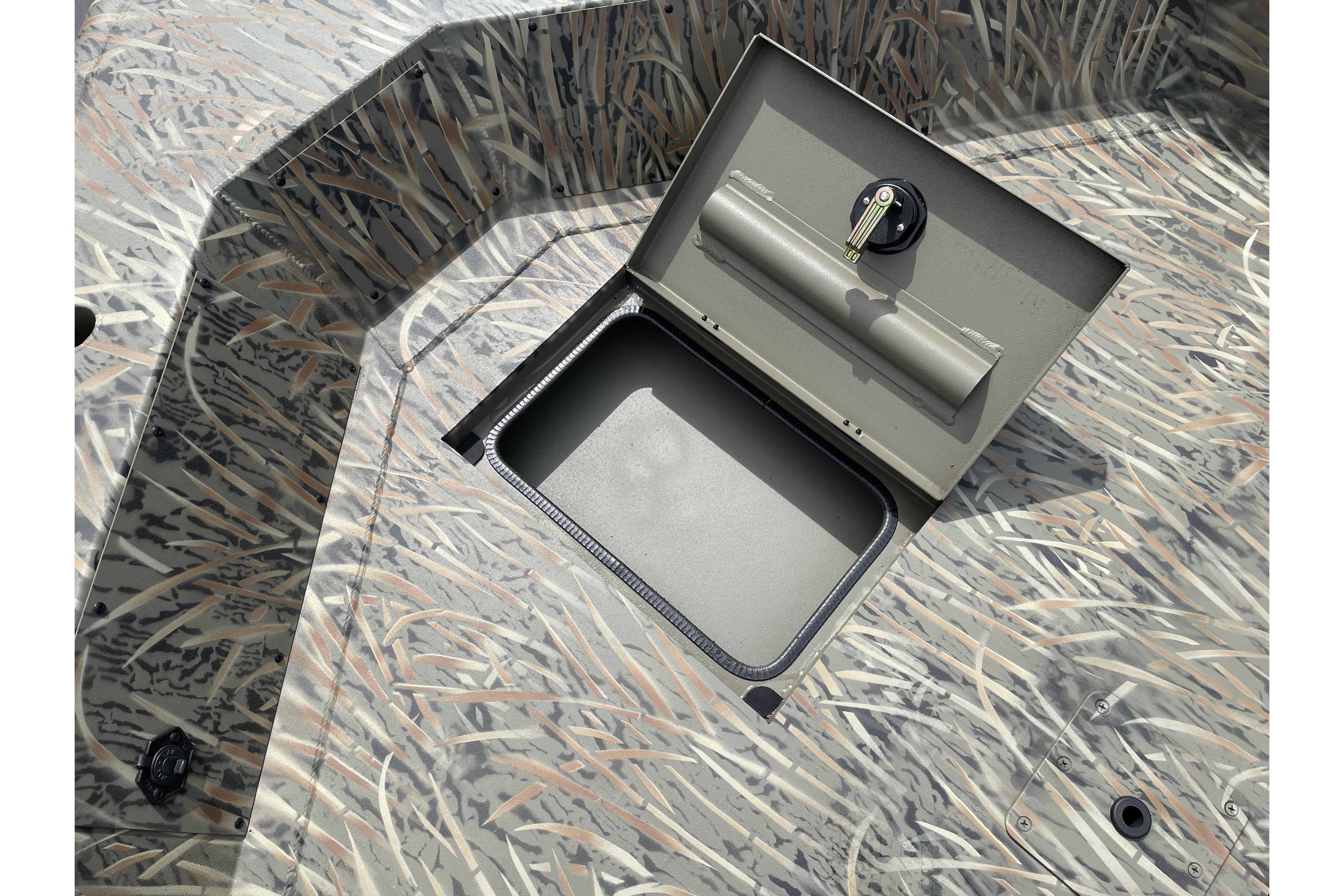 2026 Tracker Grizzly 1756 T Marsh boat with open storage compartment, camo pattern.