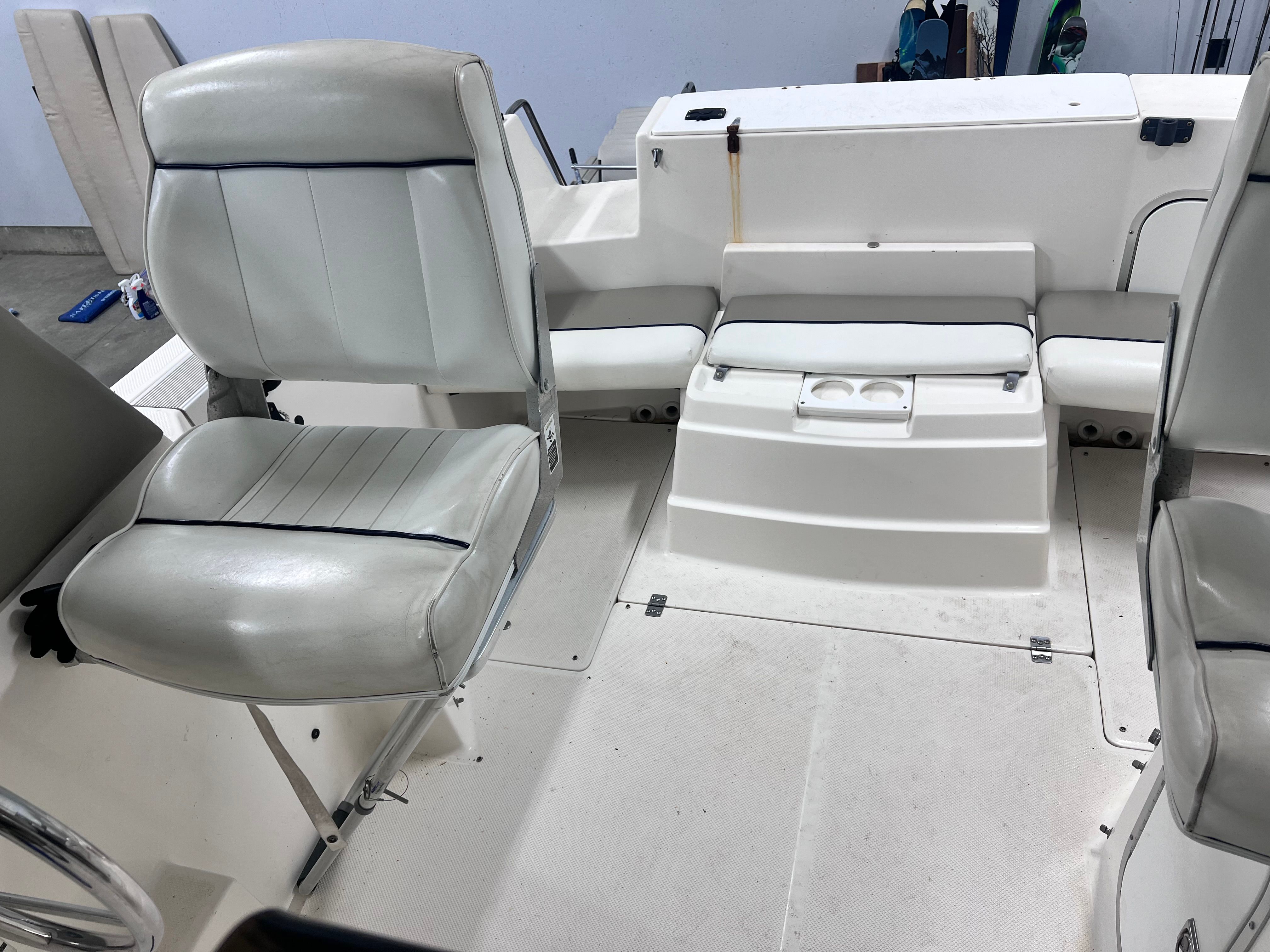 Interior of a 1997 Bayliner 2452 with white seating.