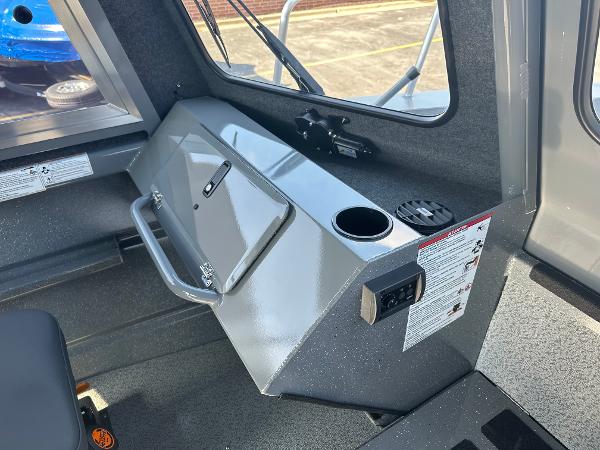 Interior of 2024 Spartan 260 Maximus Pro XL boat with storage compartment and cup holder.