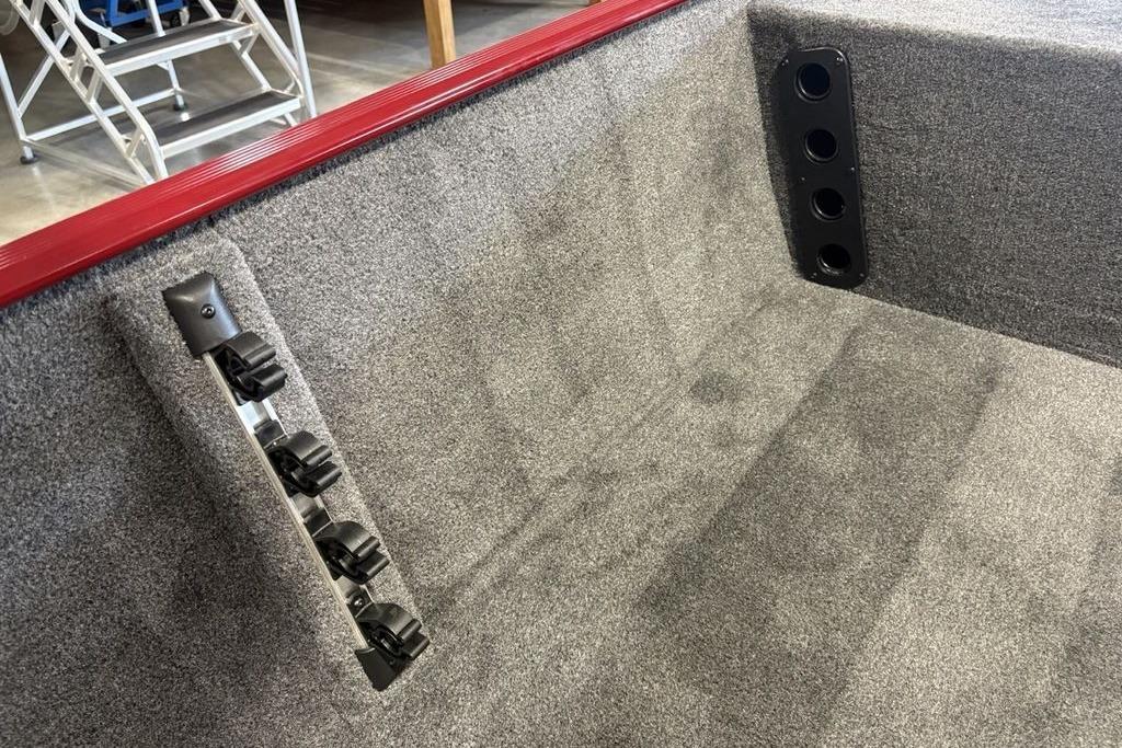 Interior of 2026 Tracker Bass Tracker Classic XL boat with carpeted finish and rod holders.