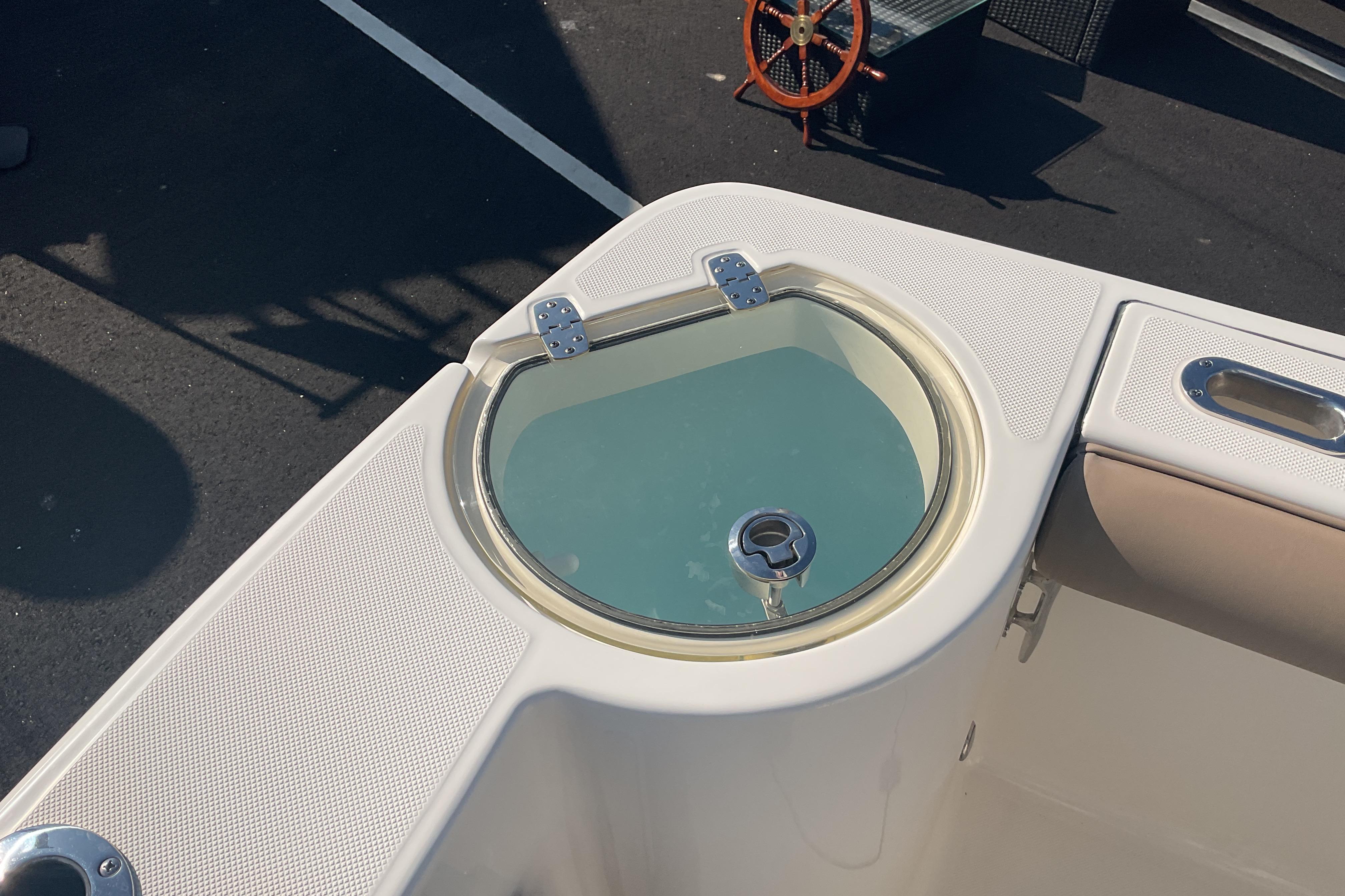 2023 Sea Born SX239 Offshore boat with a circular livewell on deck.