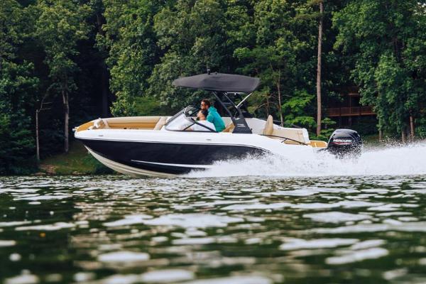 Manufacturer Provided Image: 2025 Bayliner D20 boat cruising on a lake with lush green forest backdrop.
