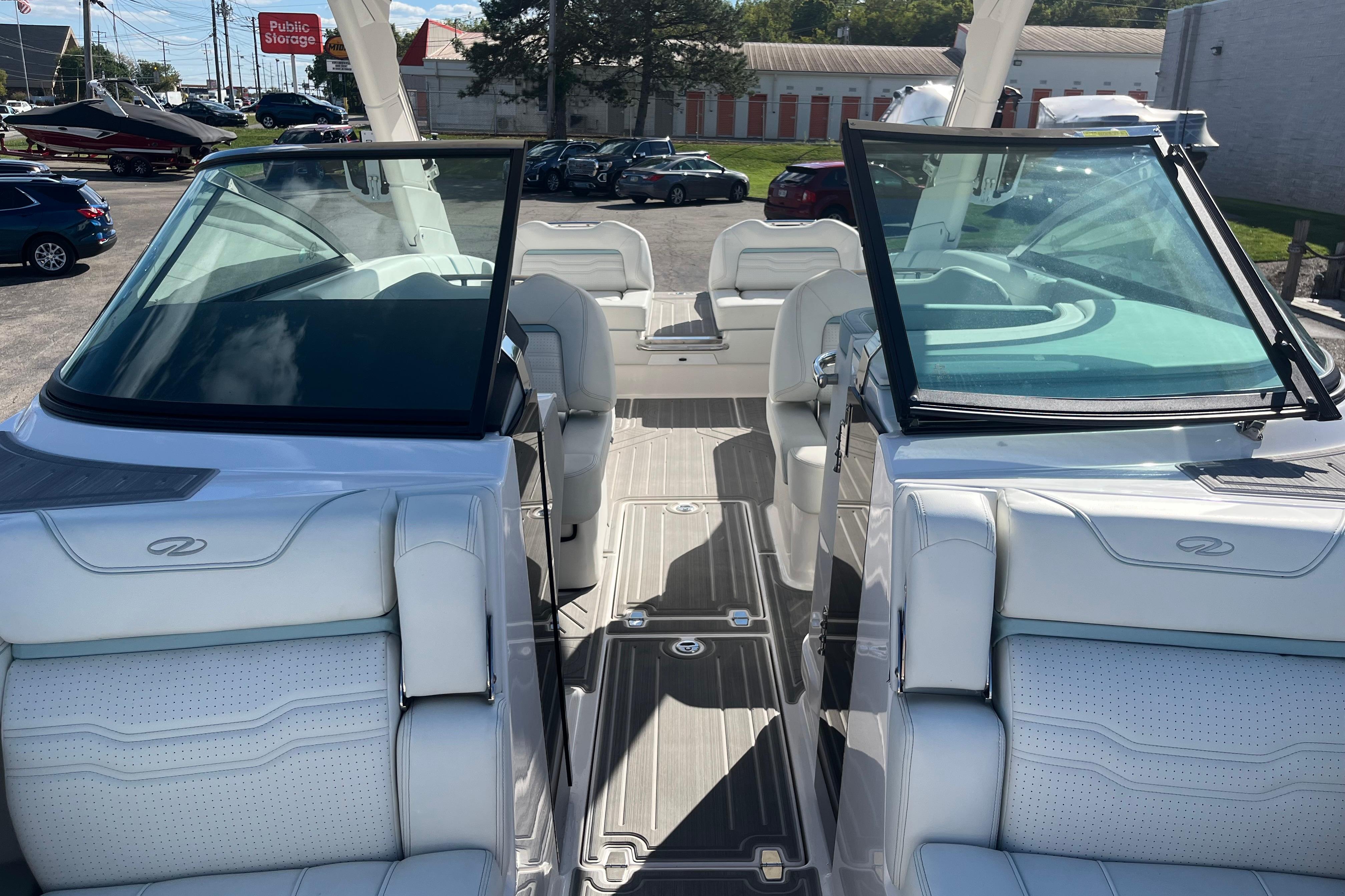 2024 Regal LS9 Surf boat interior with white seating and open windshield.