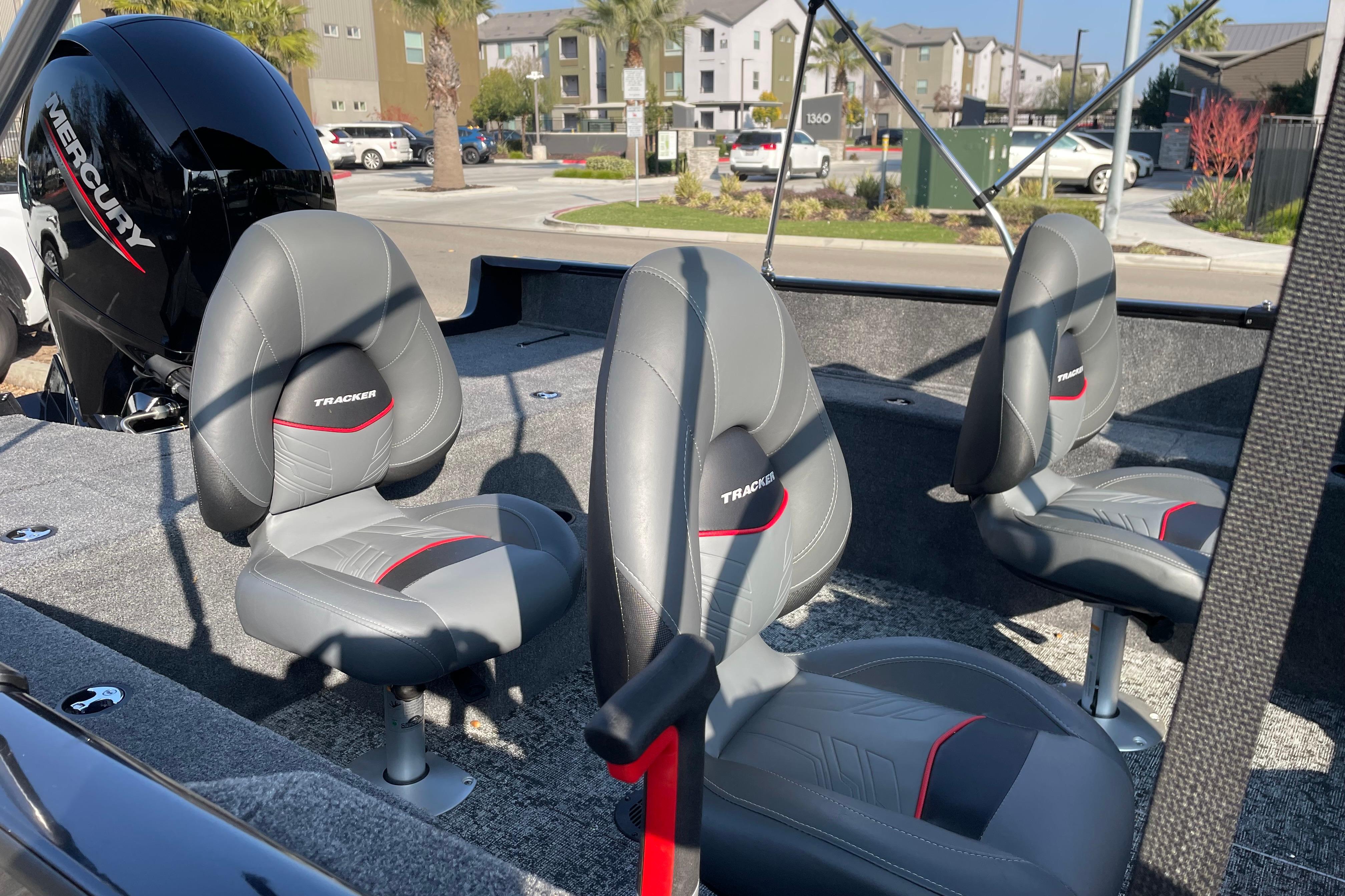 2026 Tracker Pro Guide V-175 WT boat interior with three gray seats and Mercury engine.