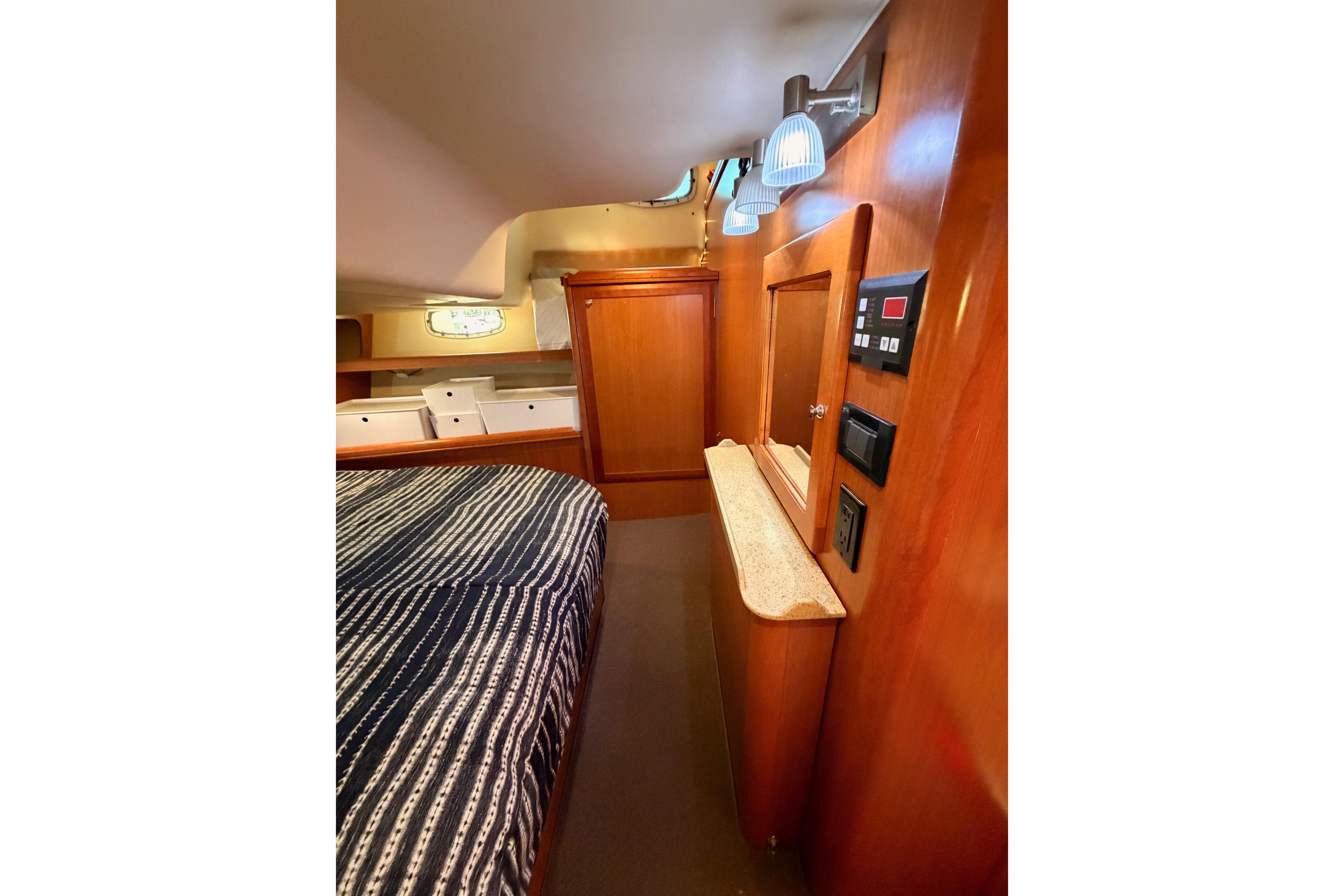 Interior of 2008 Hunter 45 Deck Salon with wood paneling and cozy sleeping area.