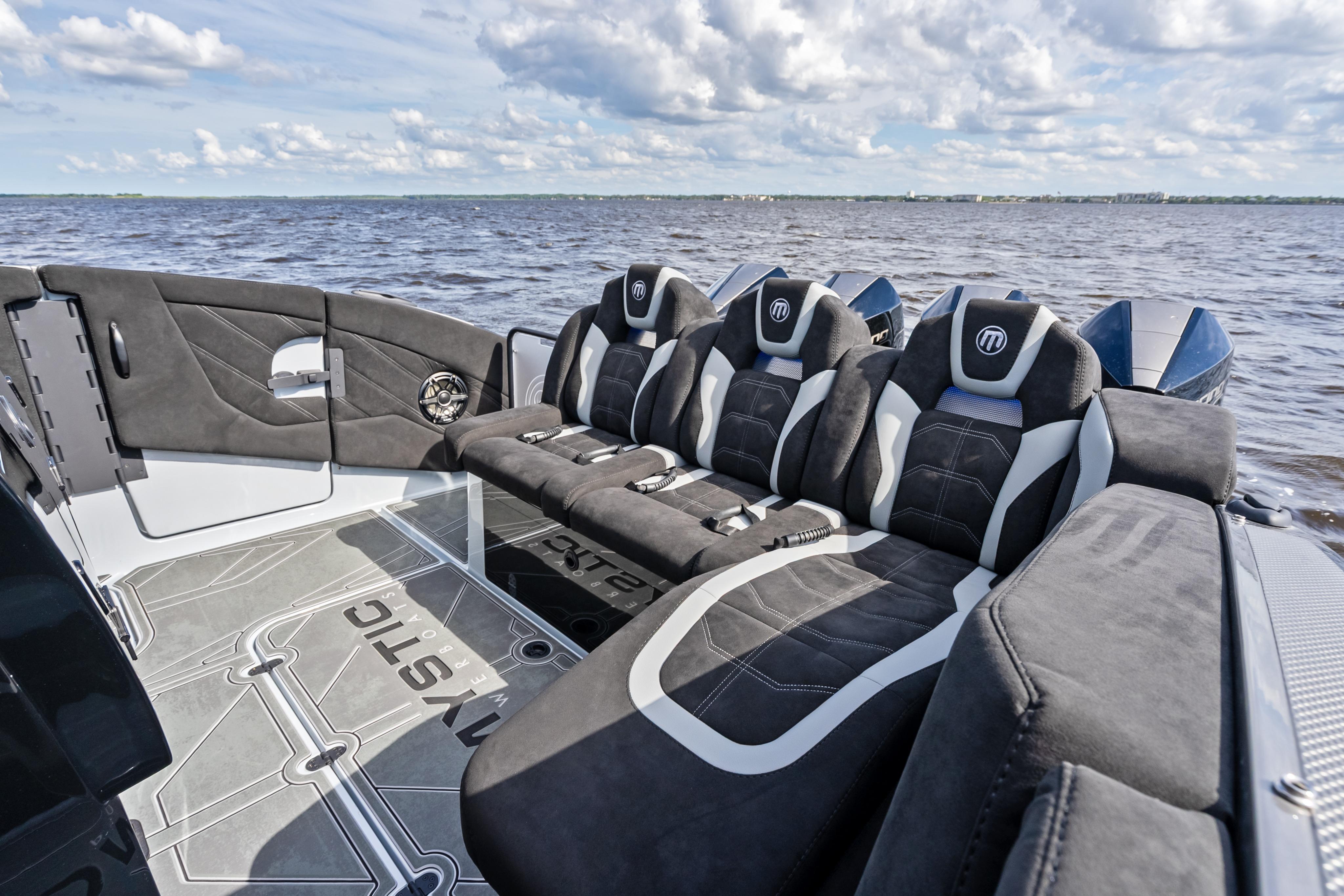 Luxurious seating on 2027 Mystic Powerboats M4200, with sleek design and waterfront view.
