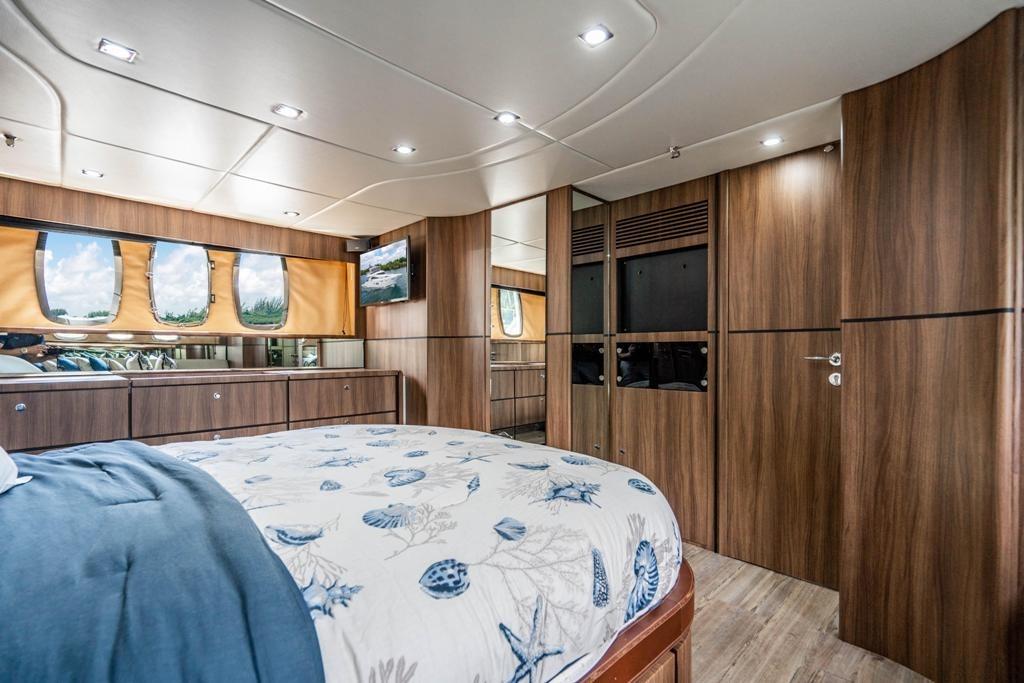 Luxurious Fairline 68 yacht bedroom interior, featuring elegant wood paneling and modern design, 2020 model.