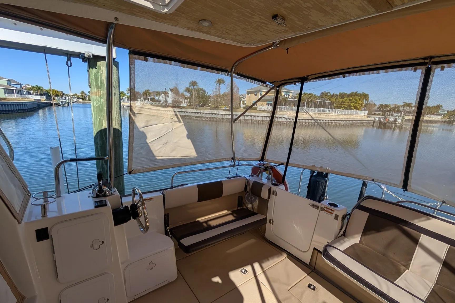 Interior view of a 2015 Ranger Tugs R-29 S boat with waterfront scenery.