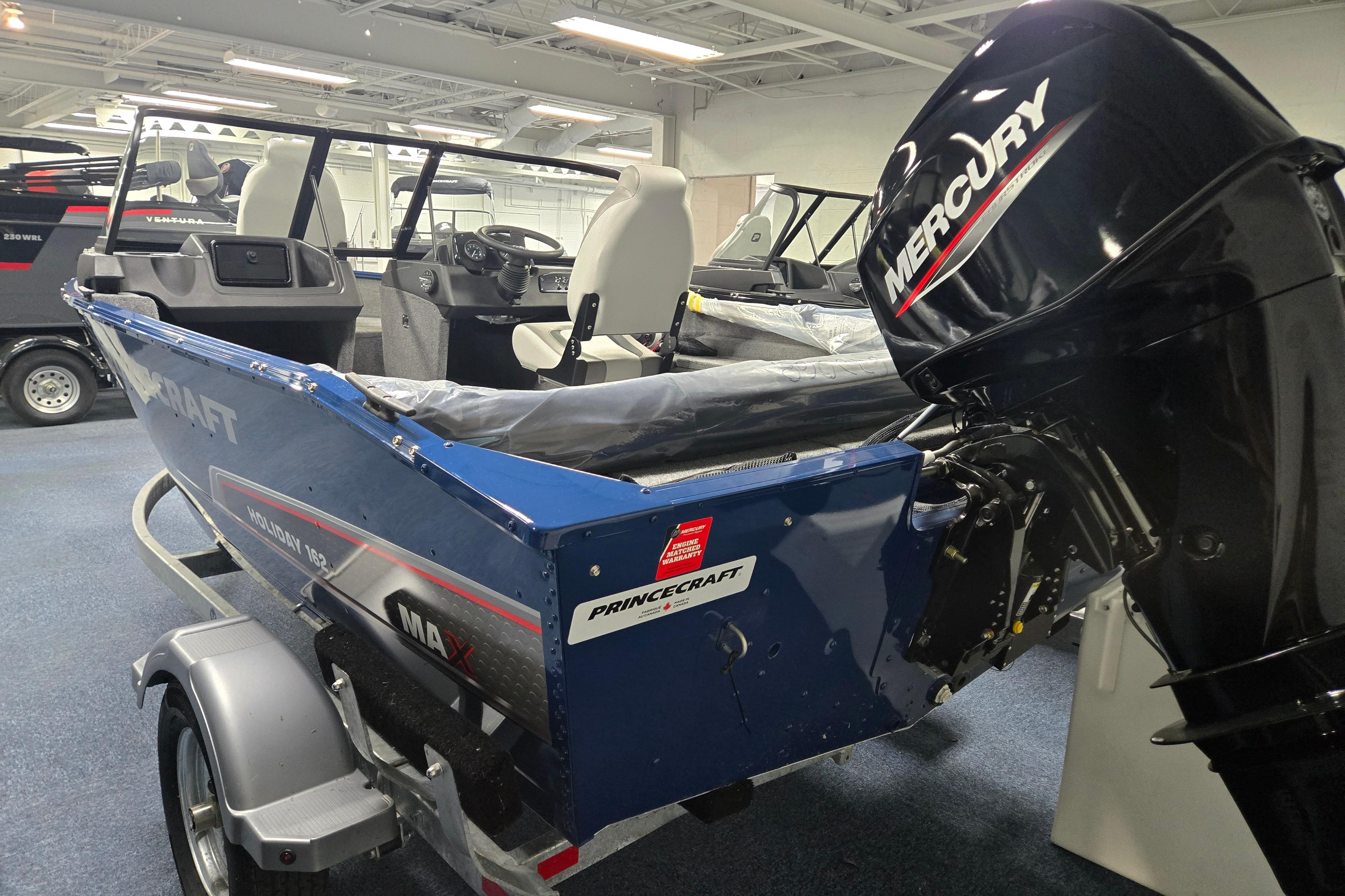 2026 Princecraft Holiday 162 WS MAX boat with Mercury engine in showroom.