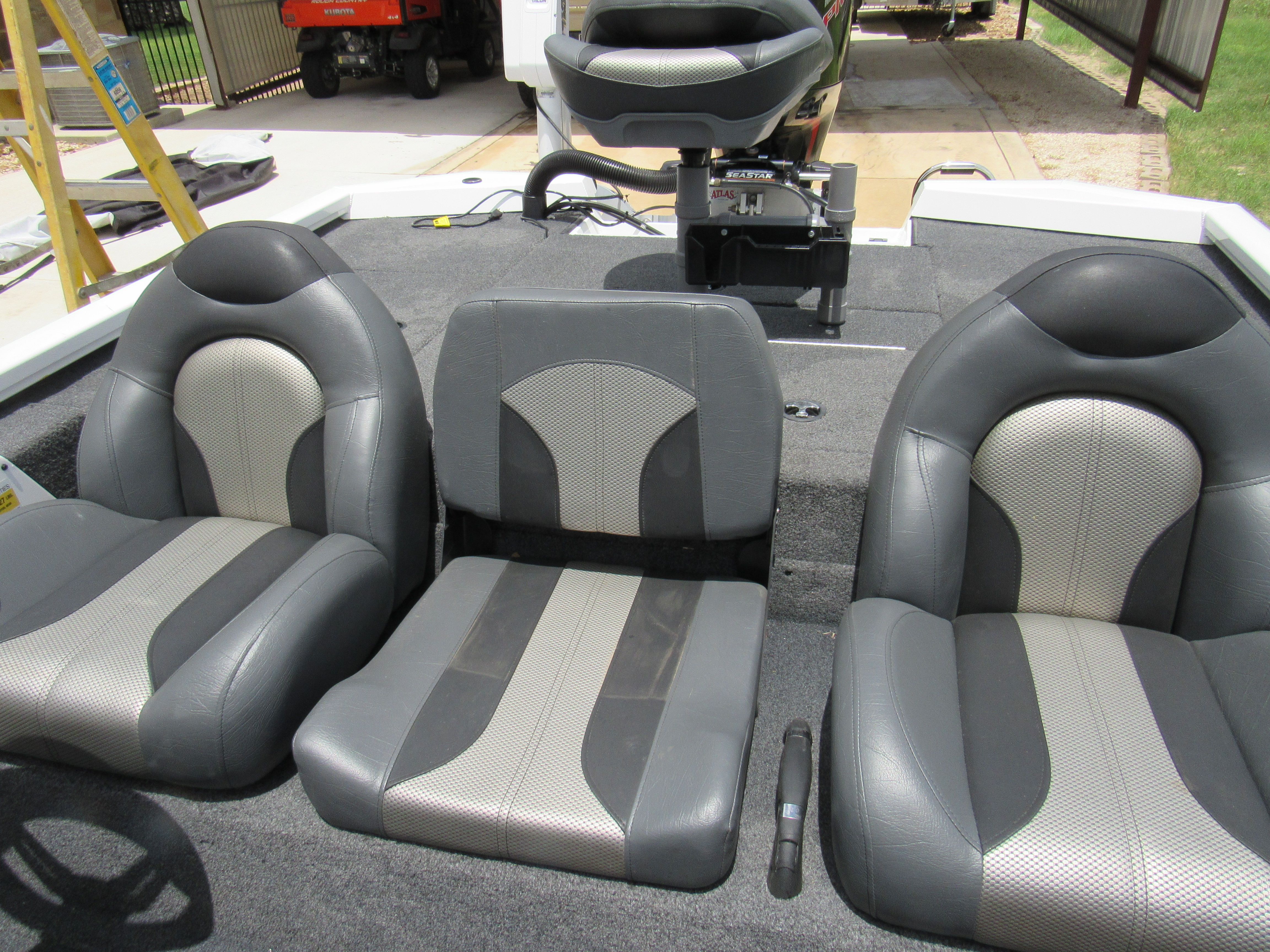 Three cushioned seats in a boat with gray and black accents.