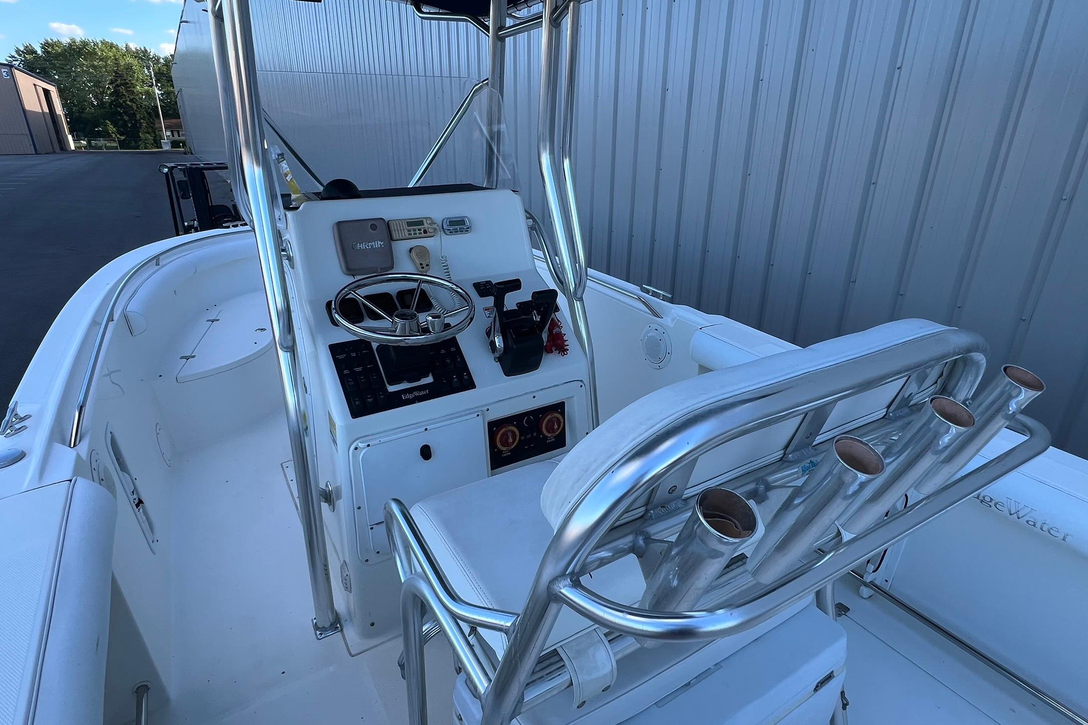 2006 Edgewater 245CC boat interior with steering console and rod holders.