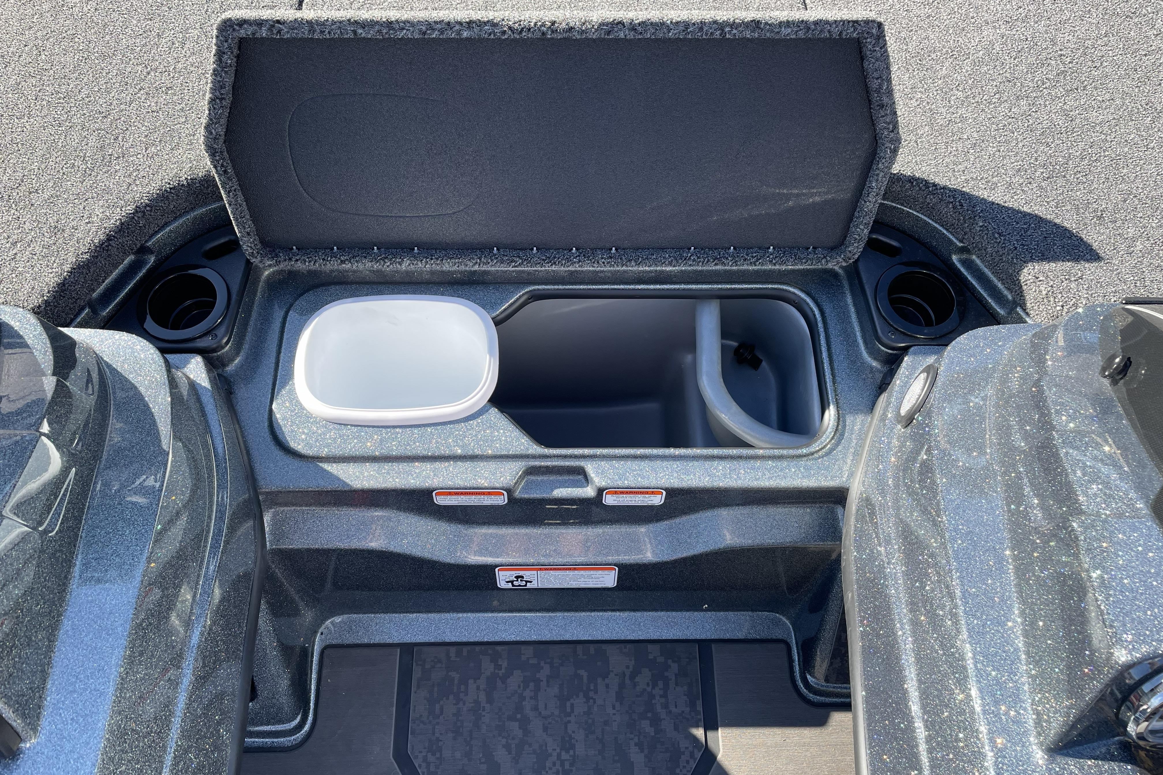 2026 Nitro Z20 XL boat storage compartment with open lid and cup holders.