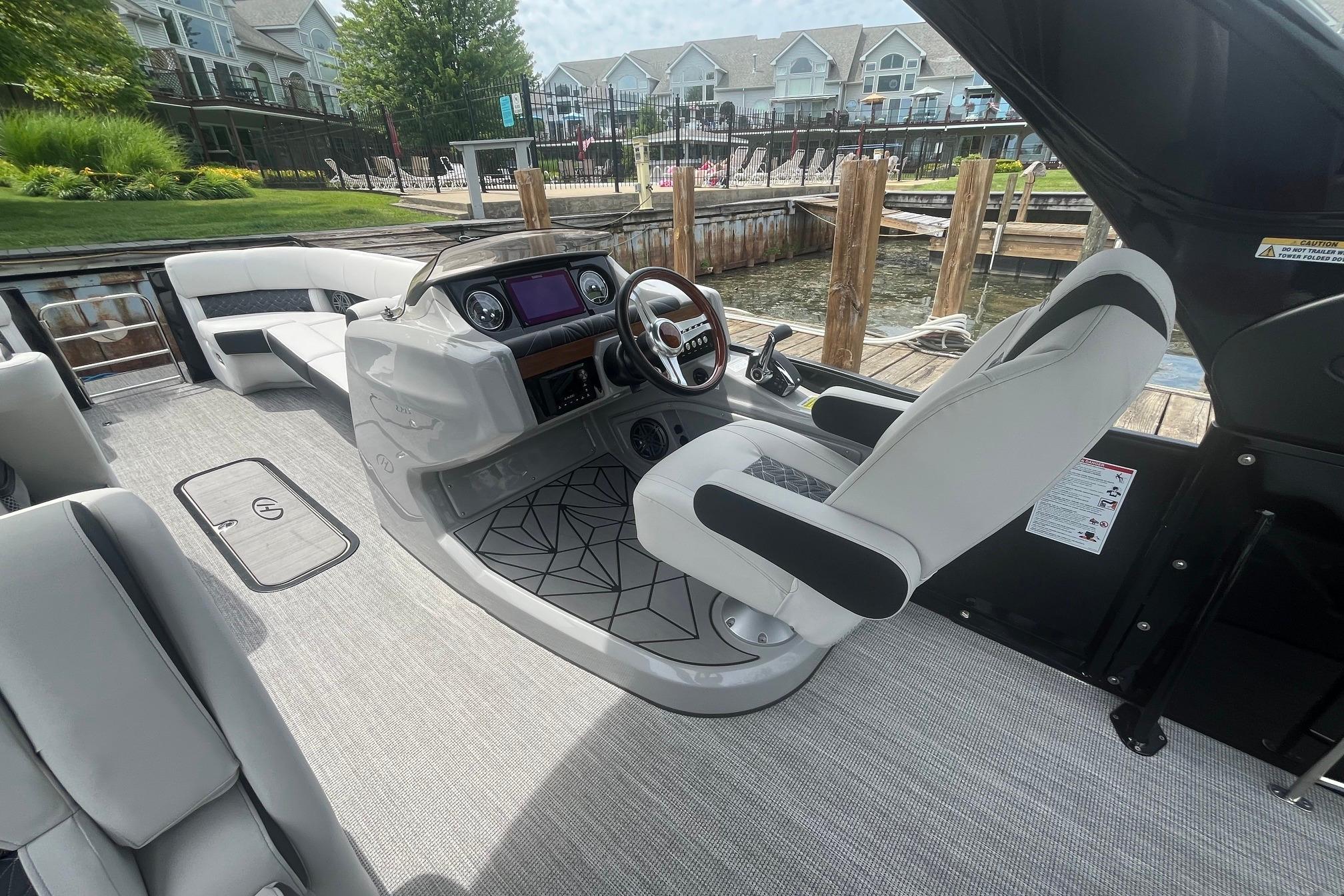 2024 Harris Grand Mariner 250 boat interior with modern helm and luxurious seating.