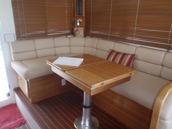 Interior of 2025 Great Harbour N40 yacht with cozy seating and wooden table.