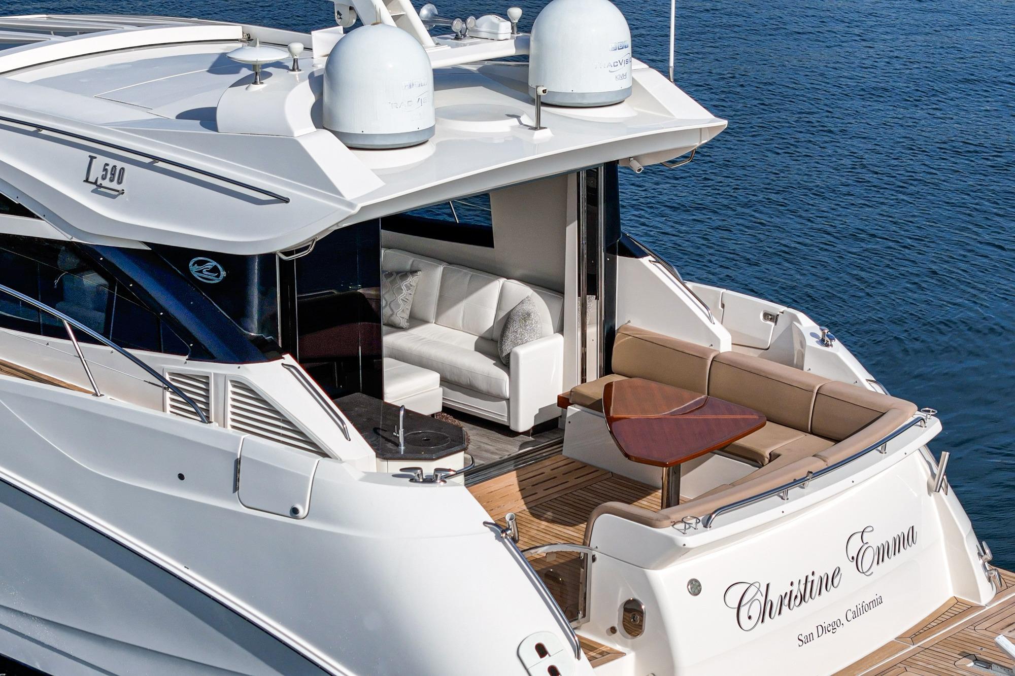 Luxurious 2016 Sea Ray L590 yacht with elegant seating, cruising on calm waters.