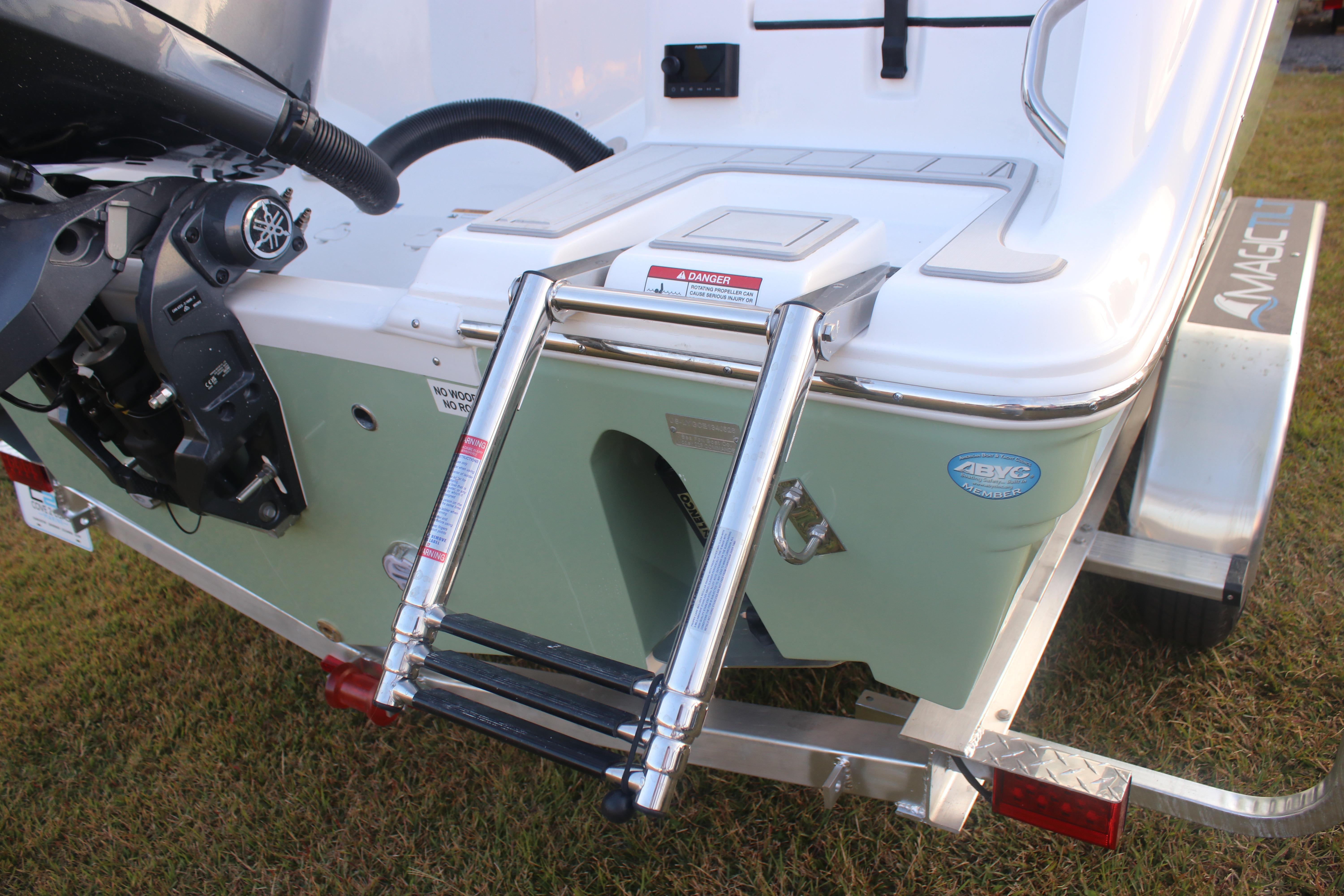 2026 Sea Fox 228 Commander boat with ladder and motor, on a trailer.