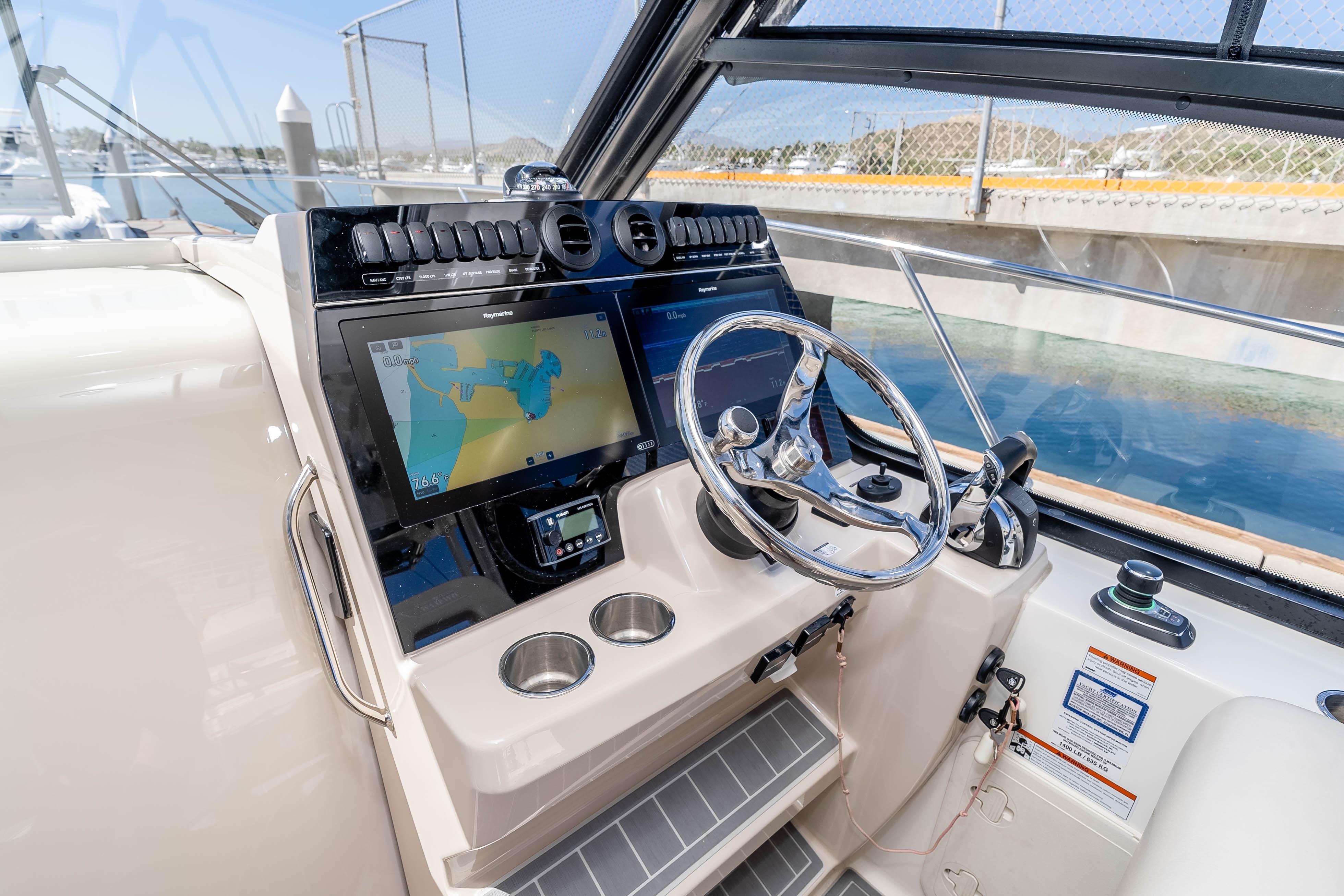 2021 Boston Whaler 325 Conquest helm with navigation display and steering wheel.