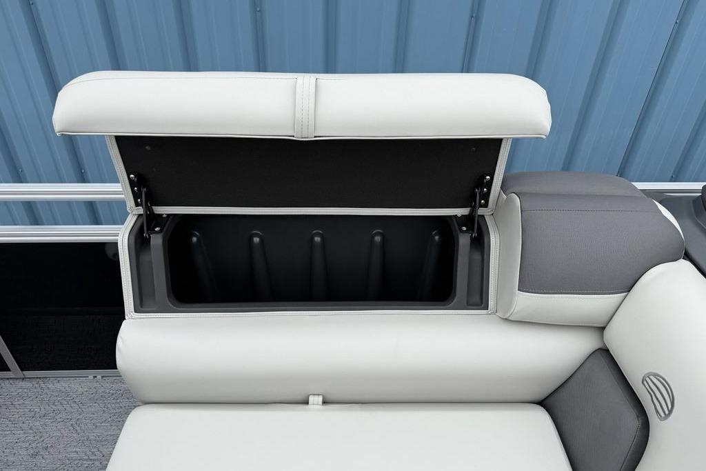 2026 Sun Tracker Fishin' Barge 20 DLX storage compartment with open cushioned seat.