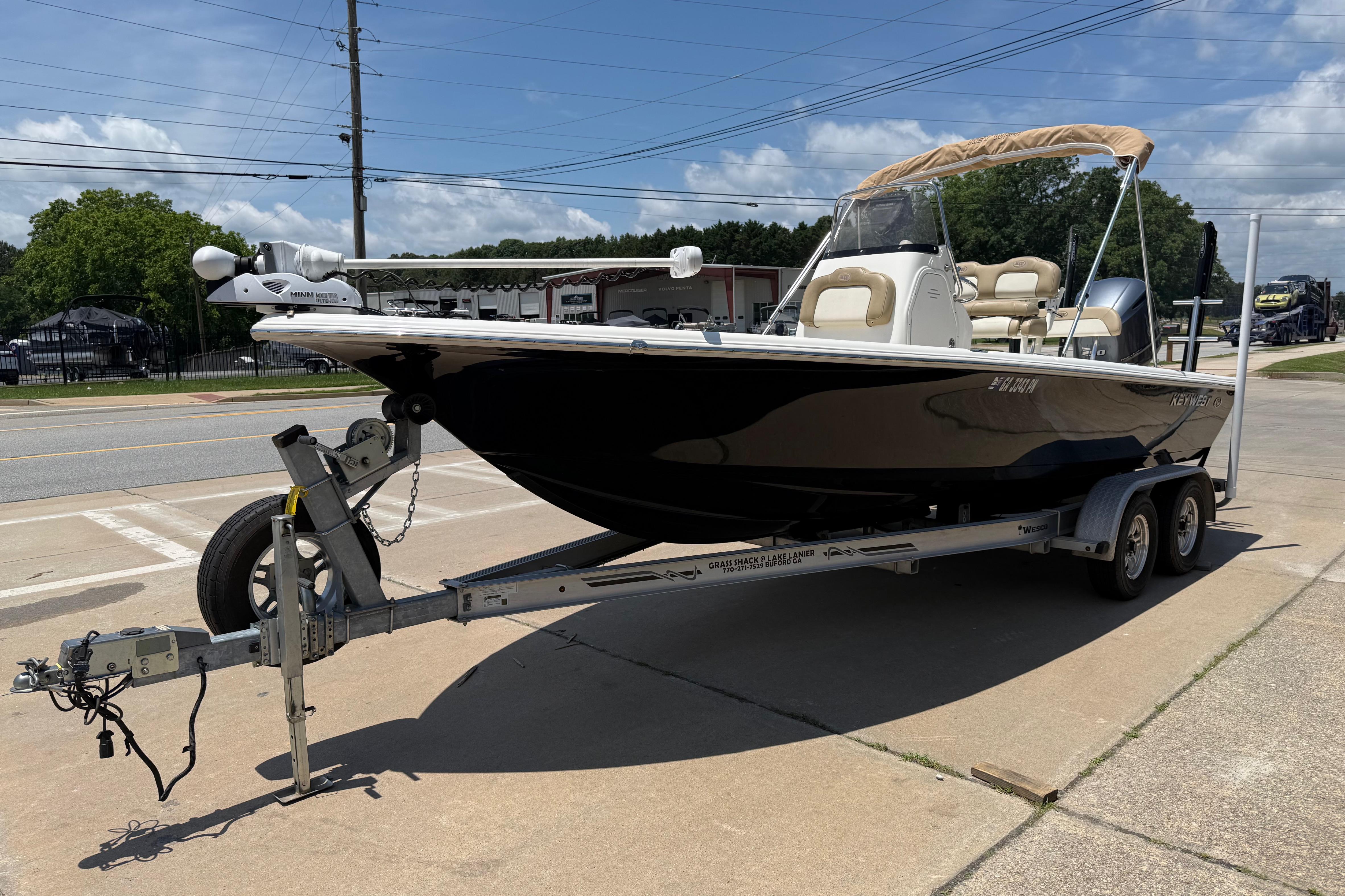 2019 Key West 230 Bay Reef boat on trailer, parked outdoors under clear sky.