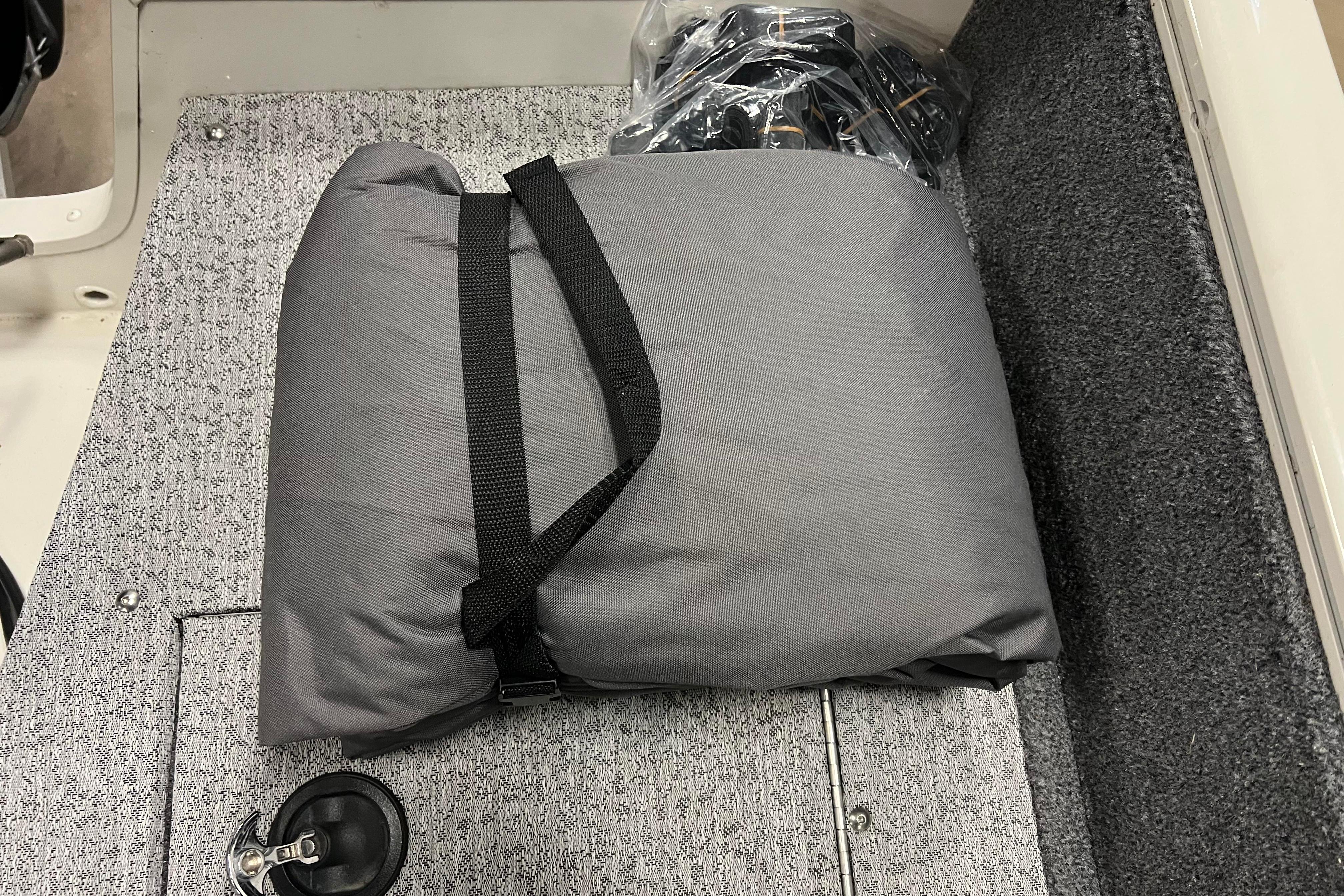 Gray cushion on 2022 Tracker Pro Guide V-16 WT boat's carpeted floor.