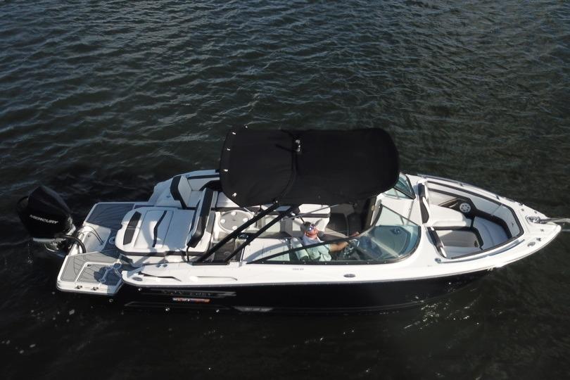 2022 Monterey 255SS Super Sport boat on water, black canopy, sleek design.