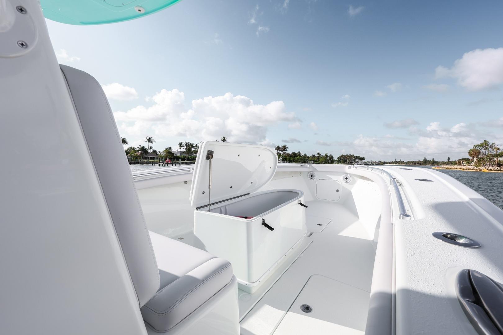 2018 Yellowfin 36 Offshore boat interior with open storage compartment, under clear blue sky.