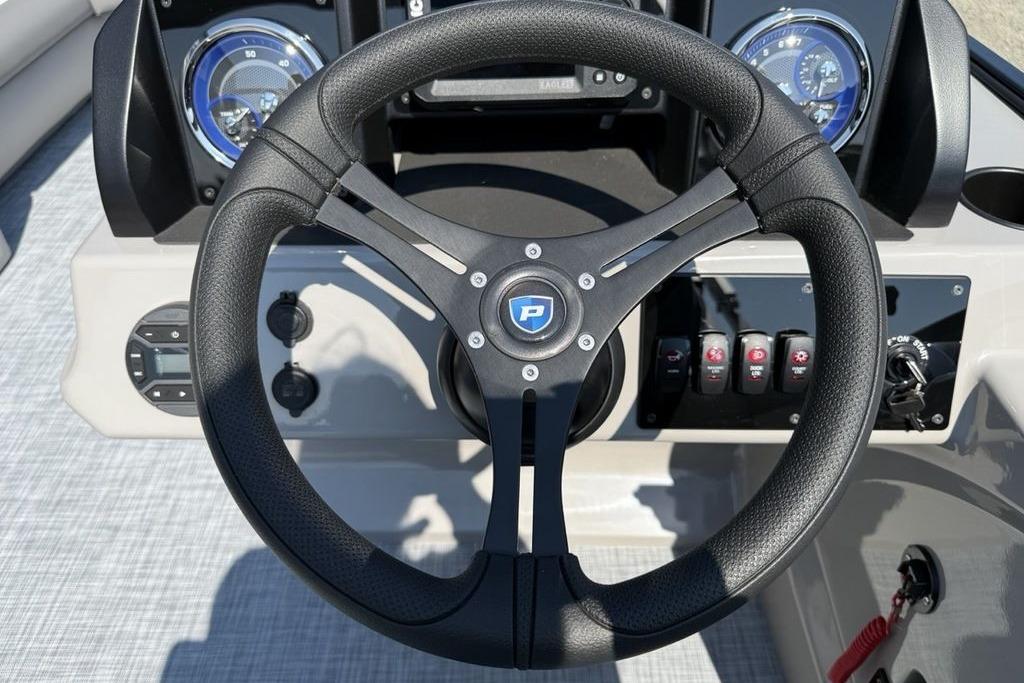 Steering wheel of 2026 Premier 220 Sunscape RF boat with dashboard controls.