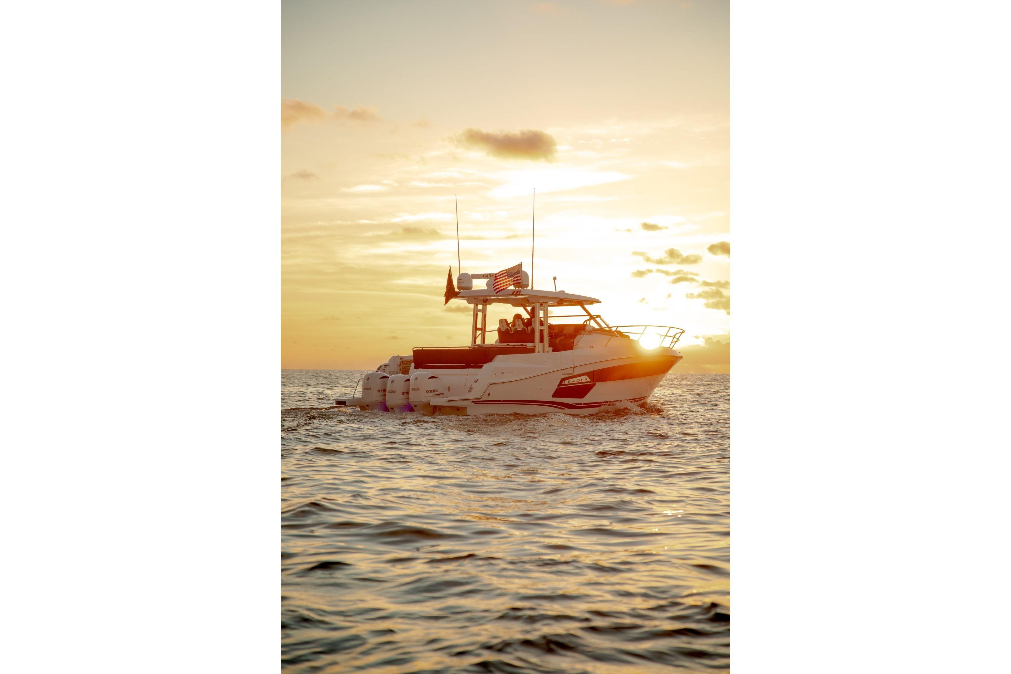 2026 Jeanneau Leader 12.5 WA boat cruising at sunset on open water.