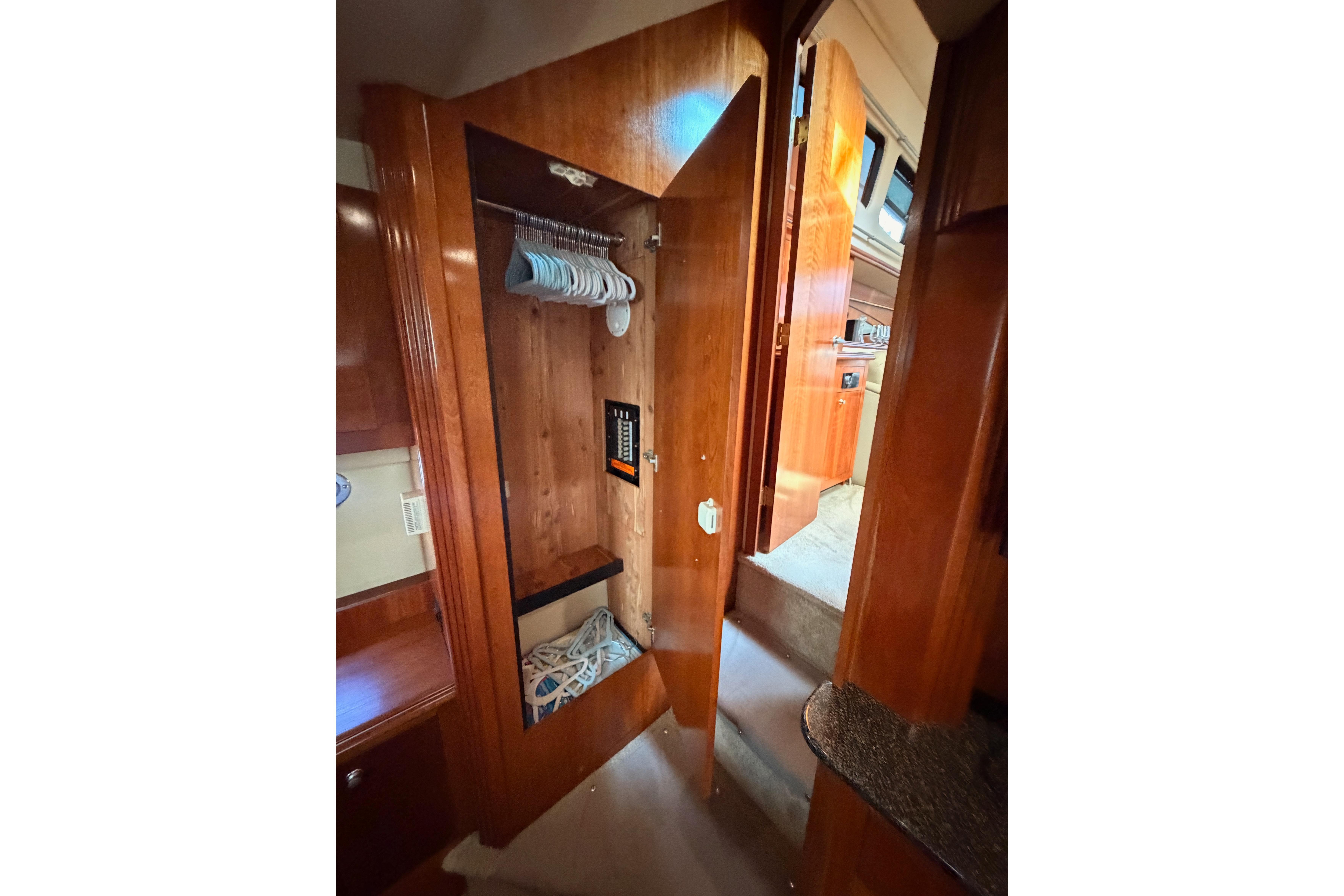 2005 Cruisers Yachts 405 Express Motoryacht interior closet with hangers and storage space.