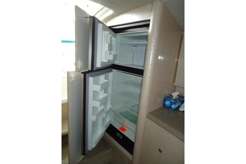 Open refrigerator inside a 1999 Formula 400 Super Sport boat cabin.