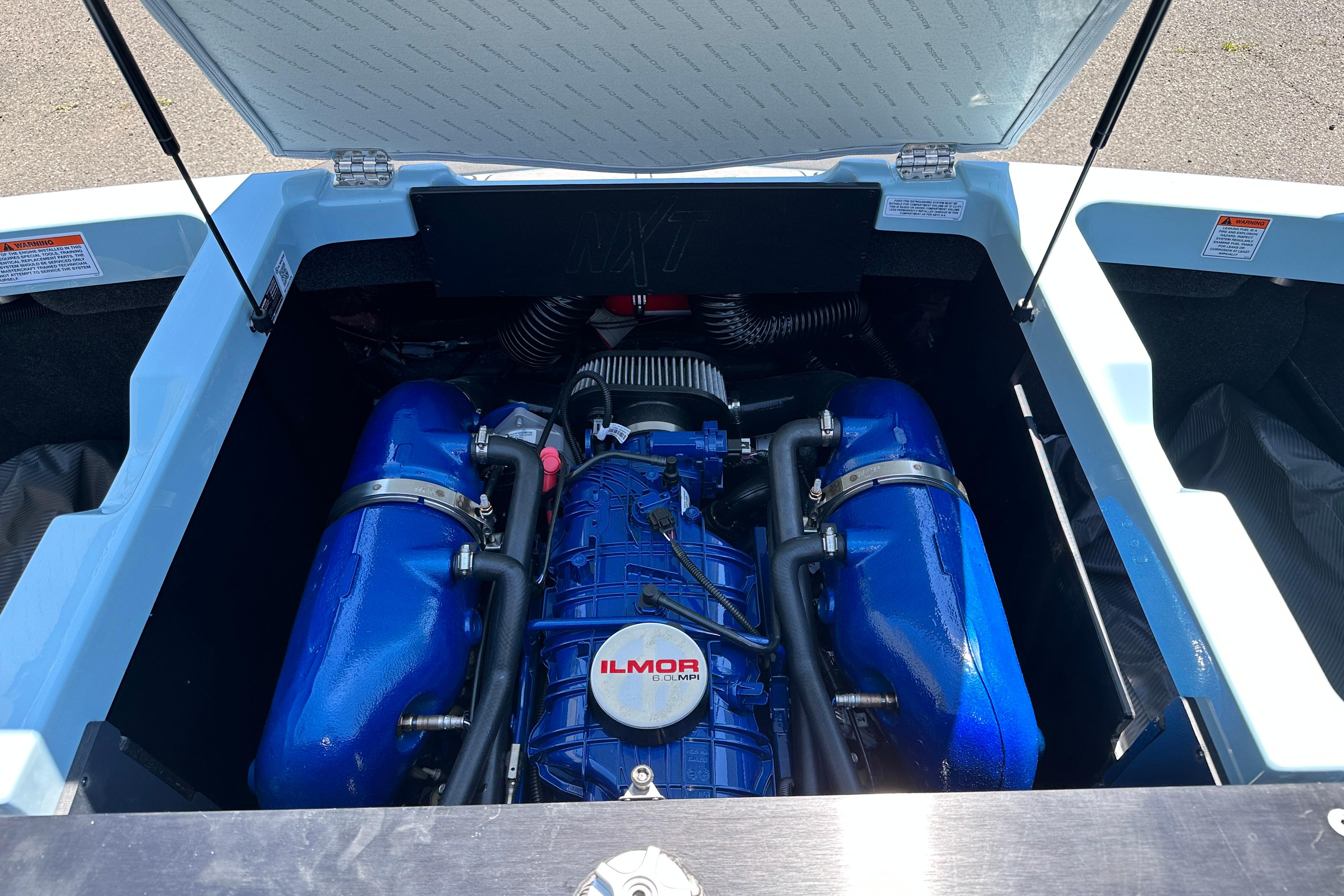 2023 MasterCraft NXT23 boat engine compartment with Ilmor engine, open hatch view.