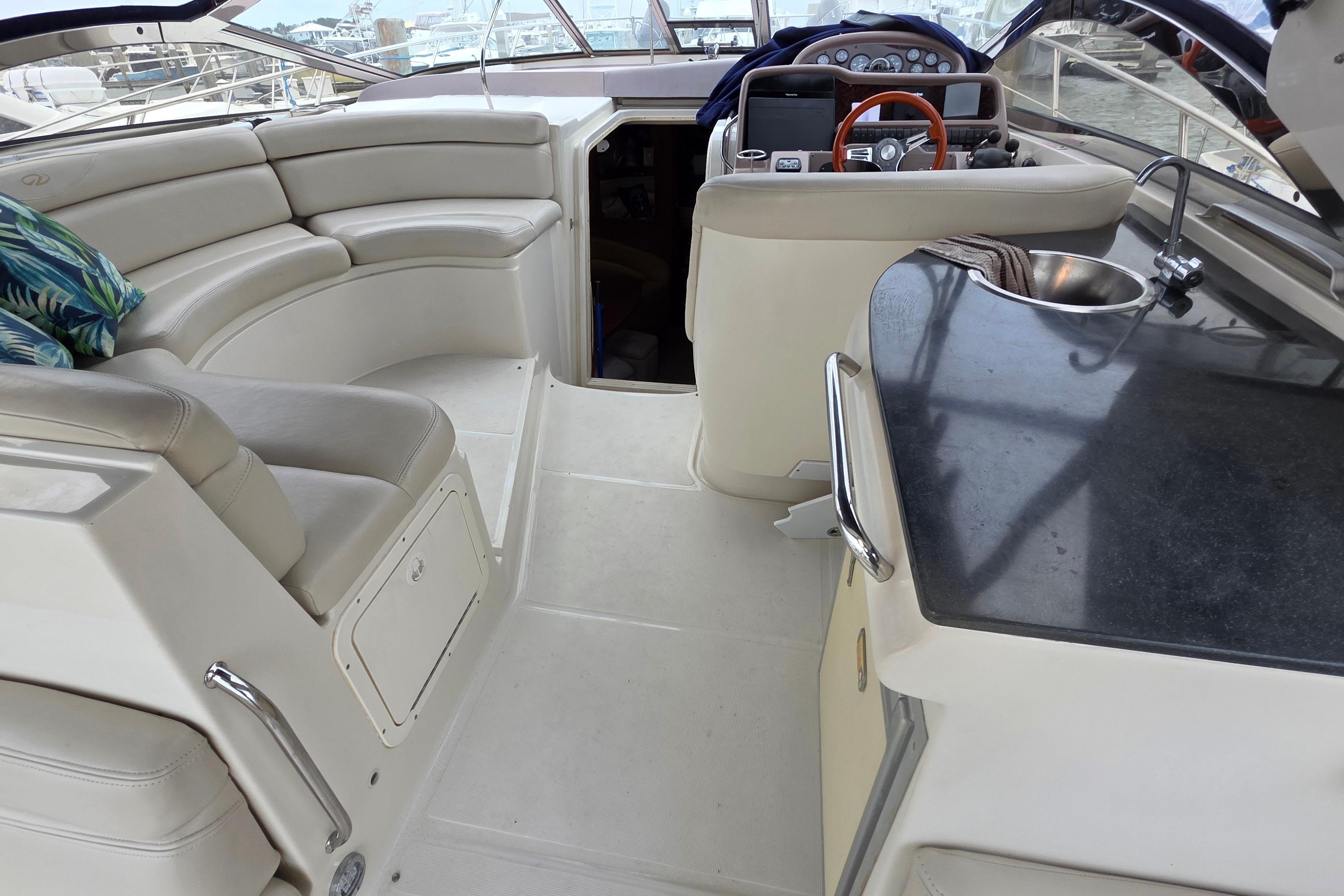 Interior of 2002 Regal Commodore 4260 yacht with seating and kitchenette.