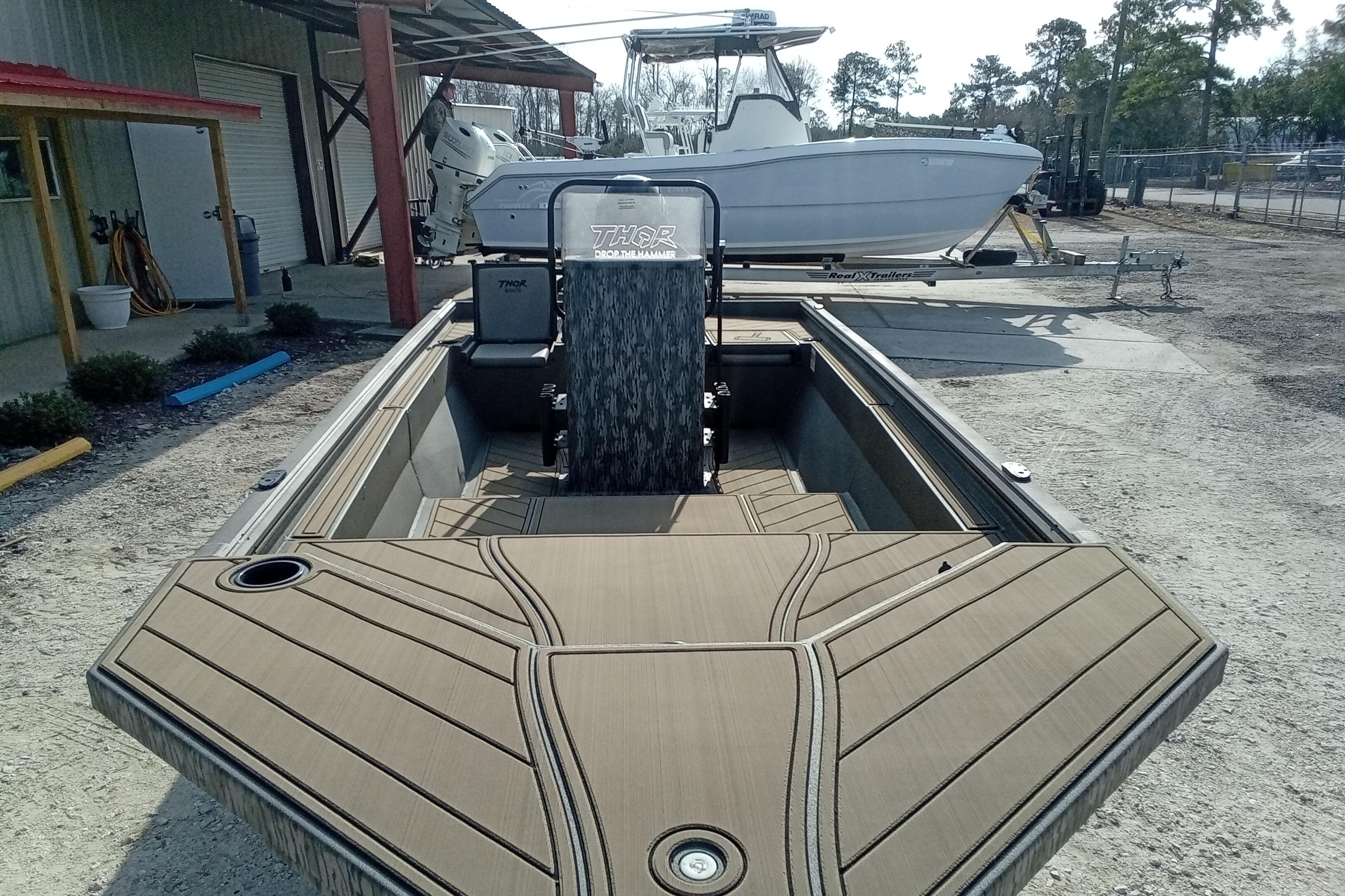 2026 Thor 1900 Low Country Elite boat with sleek design, parked outdoors.