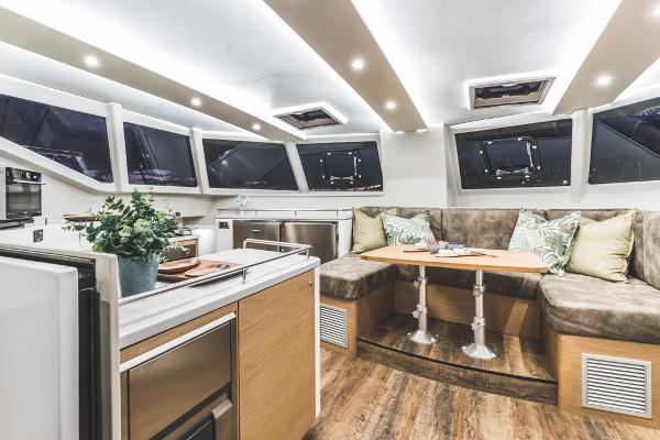 Luxurious Vision 444 yacht interior, featuring modern kitchen and cozy seating area, 2025 model.