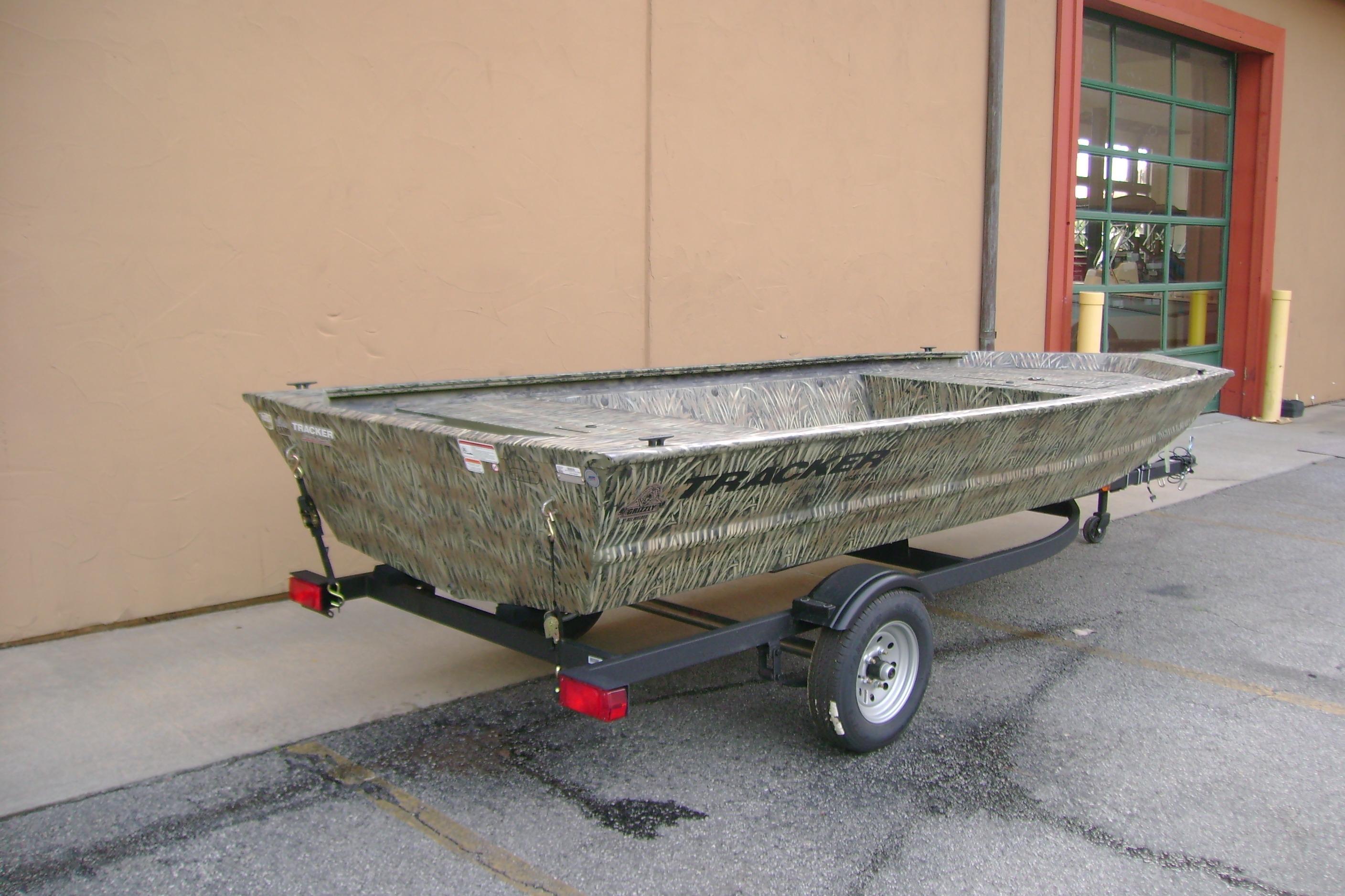 2026 Tracker Grizzly 1648 Utility boat on trailer, parked outdoors.