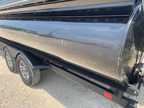 2023 Regency 250 LE3 boat trailer with dual wheels on a gravel surface.