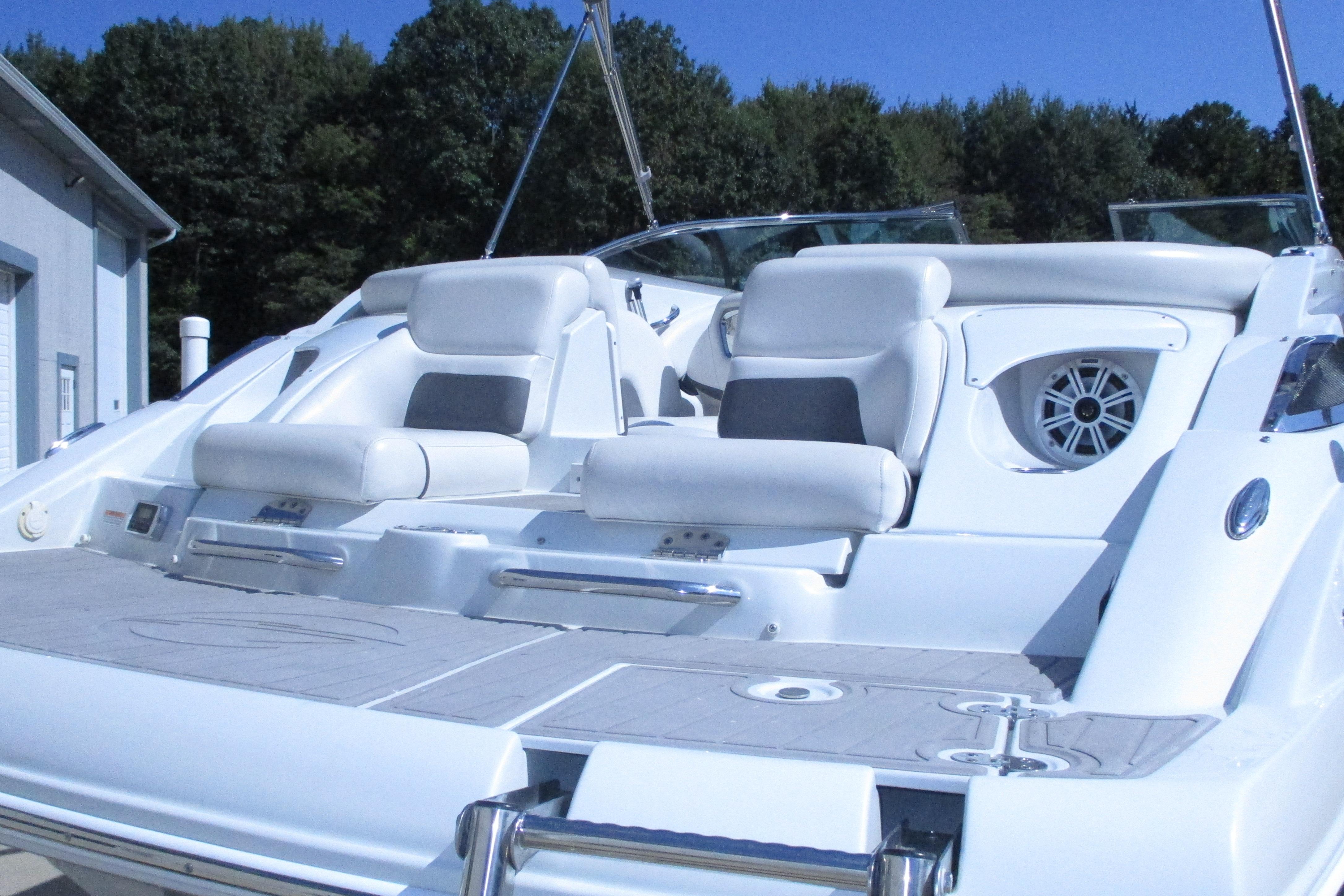 2017 Crownline 255 SS boat with white seating and sleek design, docked outdoors.