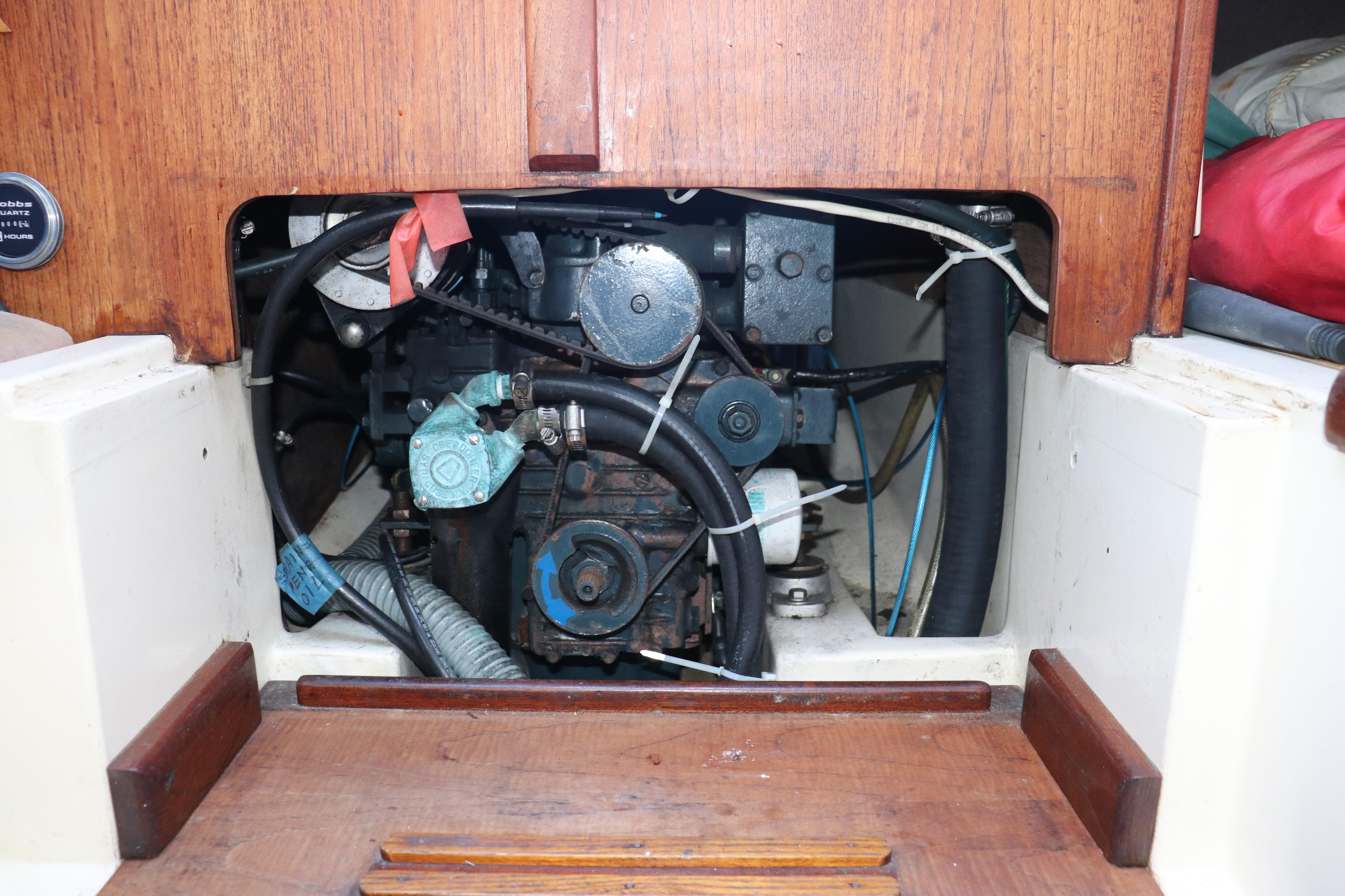 Engine compartment of a 1982 Pacific Seacraft Flicka 20 sailboat, showcasing mechanical components.