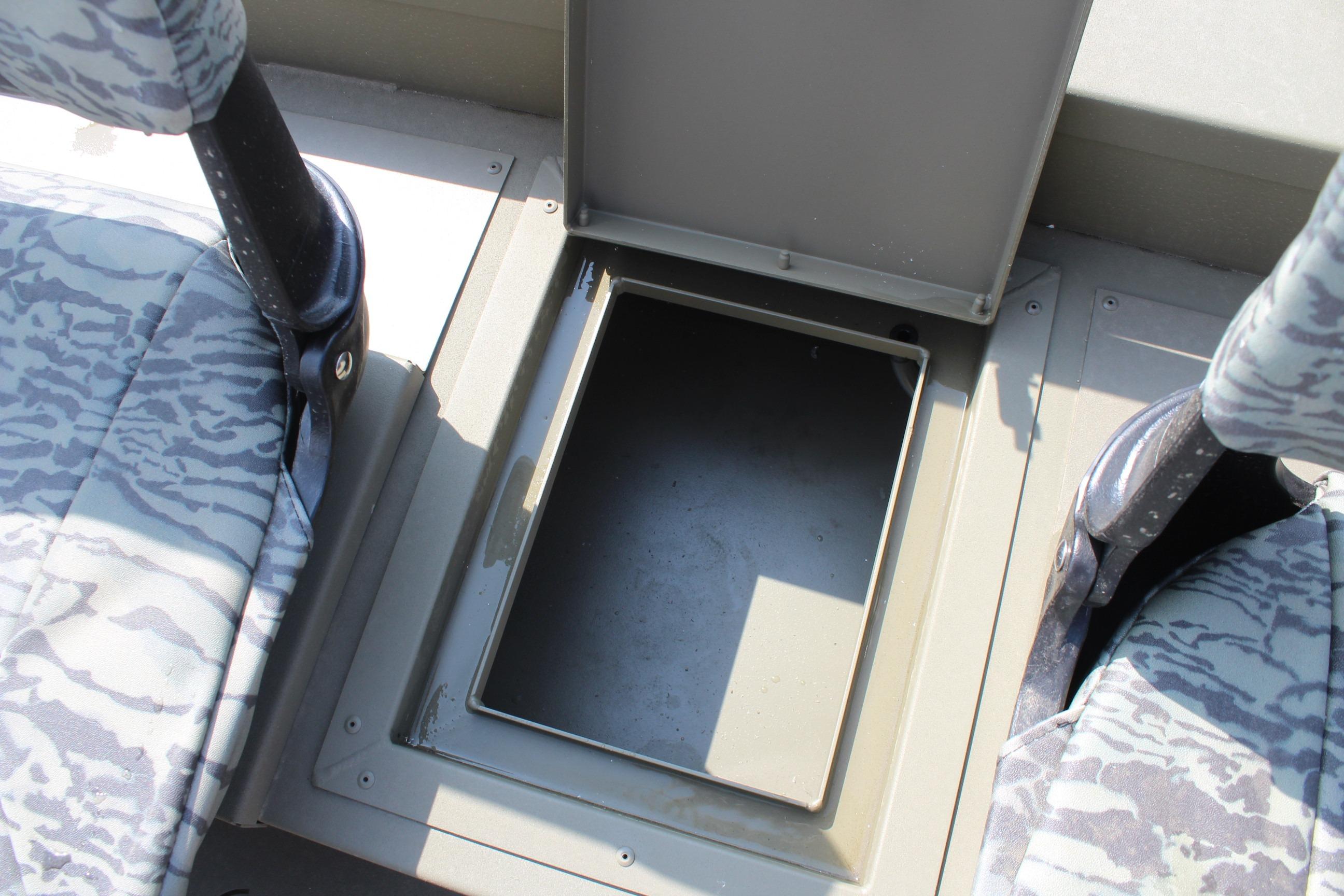 2026 Tracker Grizzly 1754 SC boat storage compartment between camo-patterned seats.