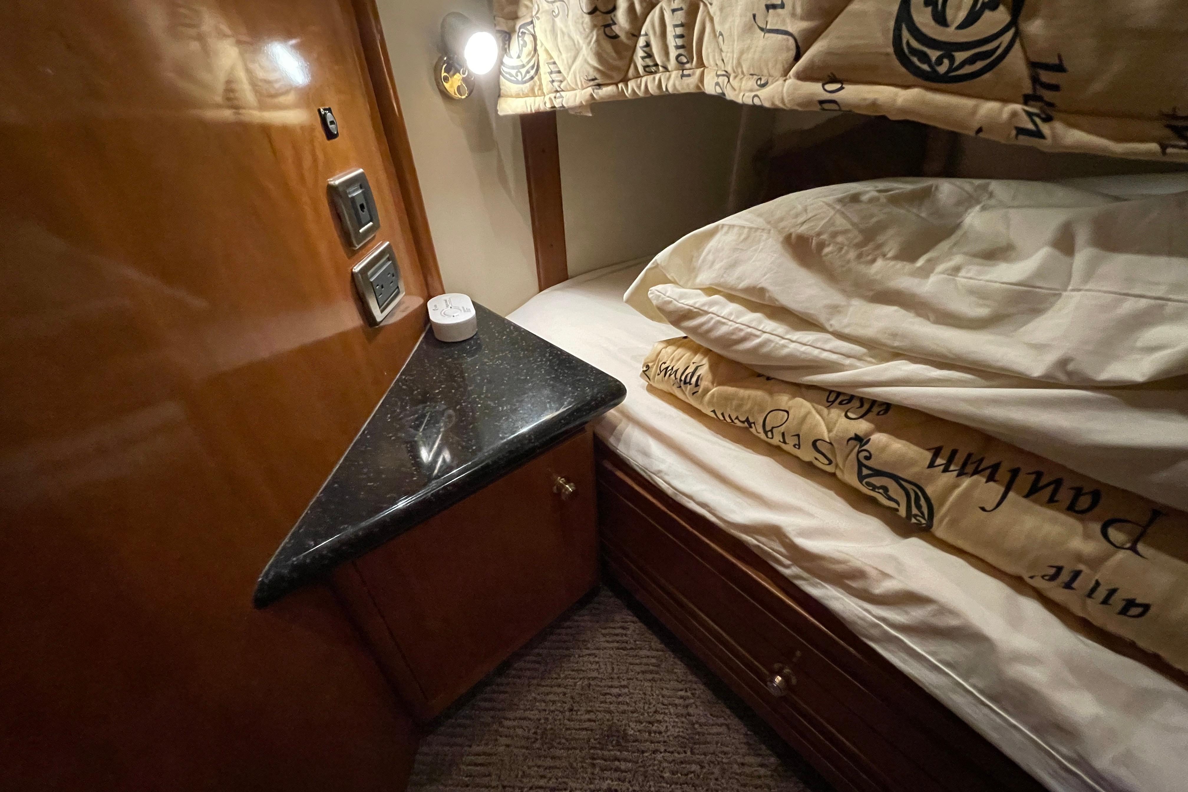 Cozy cabin interior of 2002 Carver 570 Voyager Pilothouse with bed and wooden cabinetry.