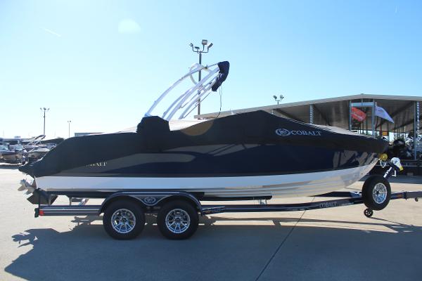2025 Cobalt CS23 boat on trailer, covered, parked outdoors.