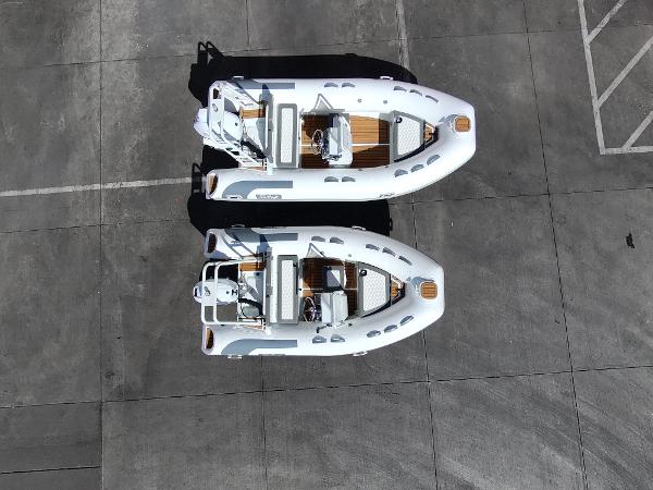 Two 2025 Tide Craft San Juan 11 boats parked on a concrete surface, aerial view.