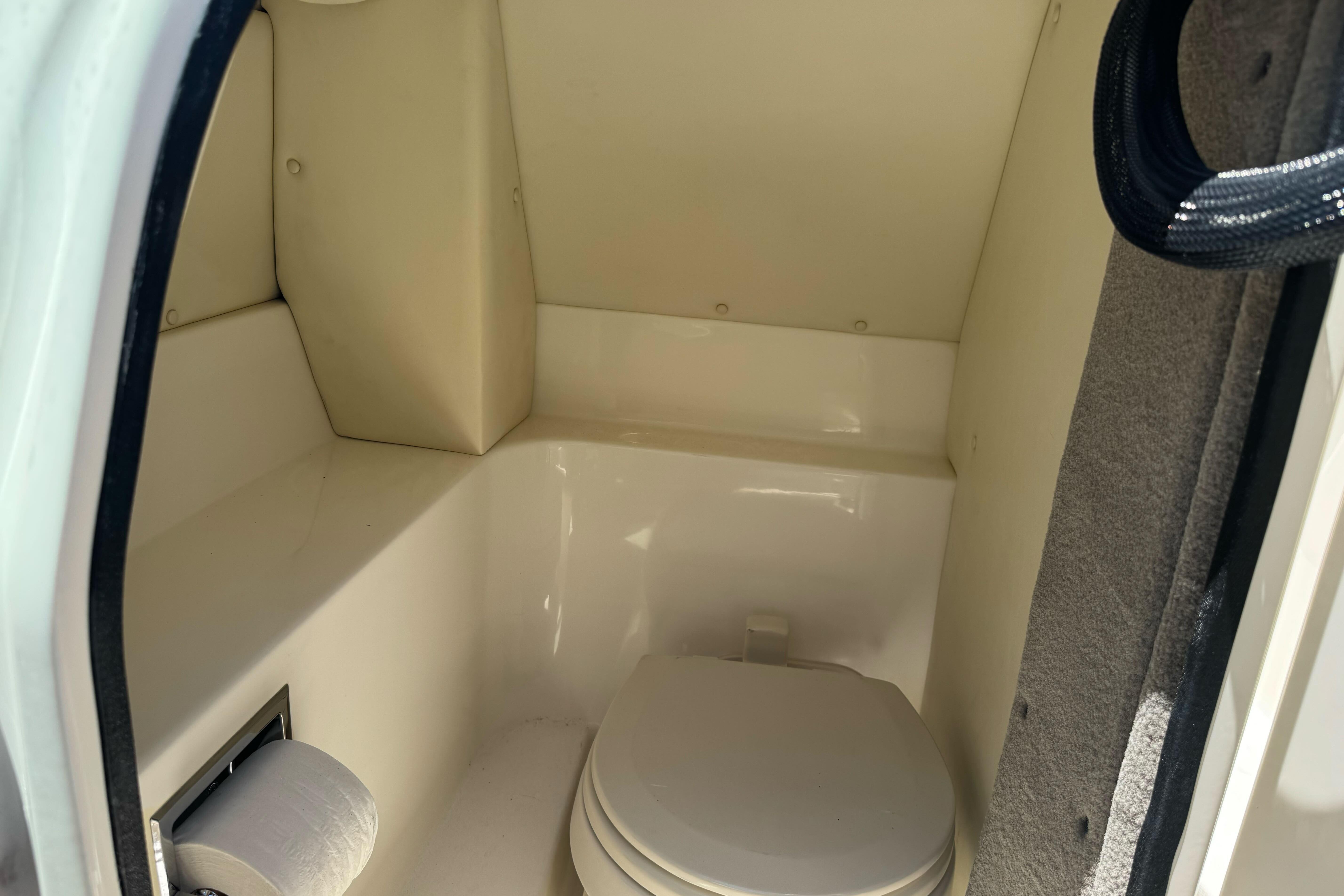 2007 Sea Ray SLX 250 boat interior with compact marine toilet.