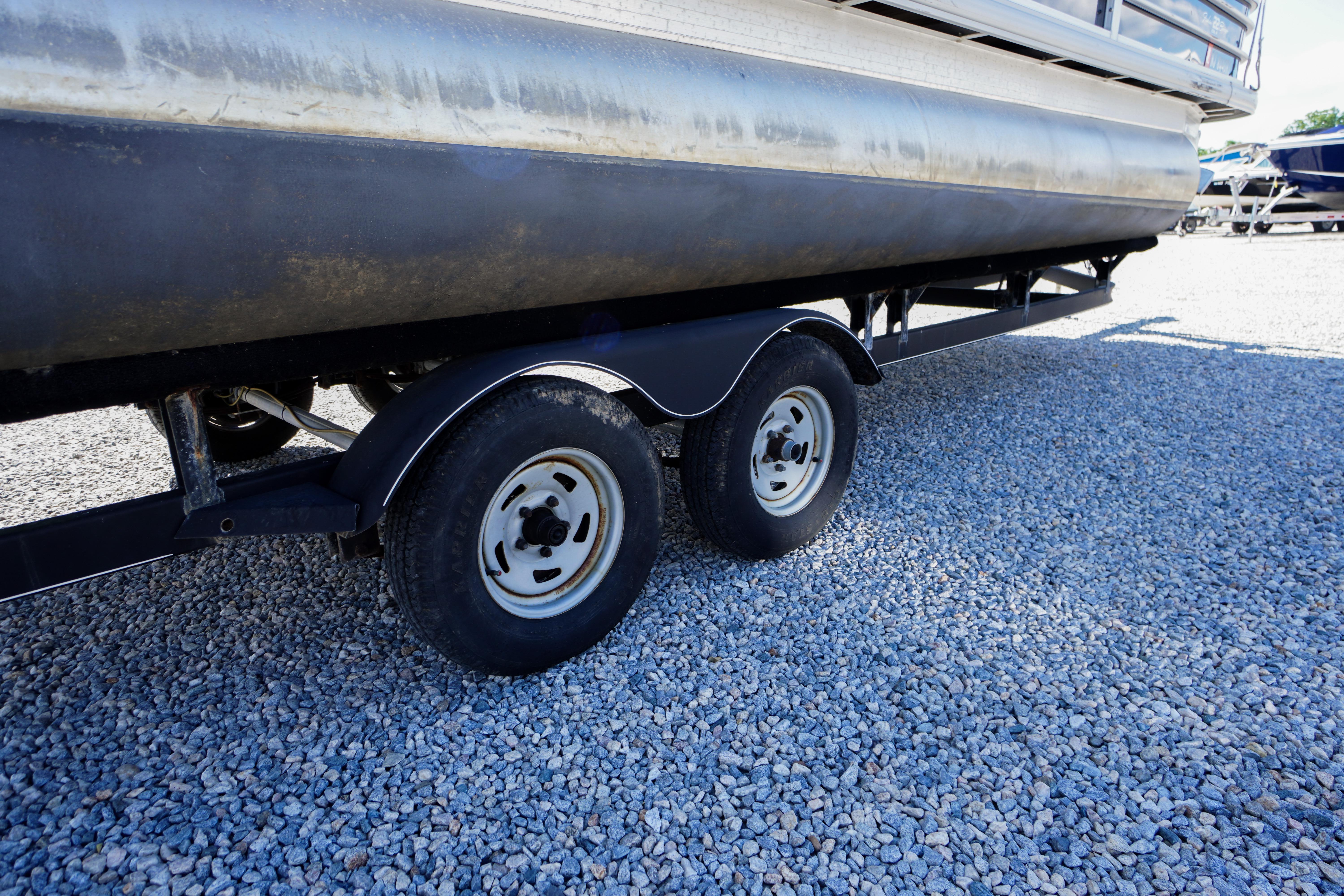2019 SUNTRACKER Fishin' Barge 22 DLX trailer on gravel surface.