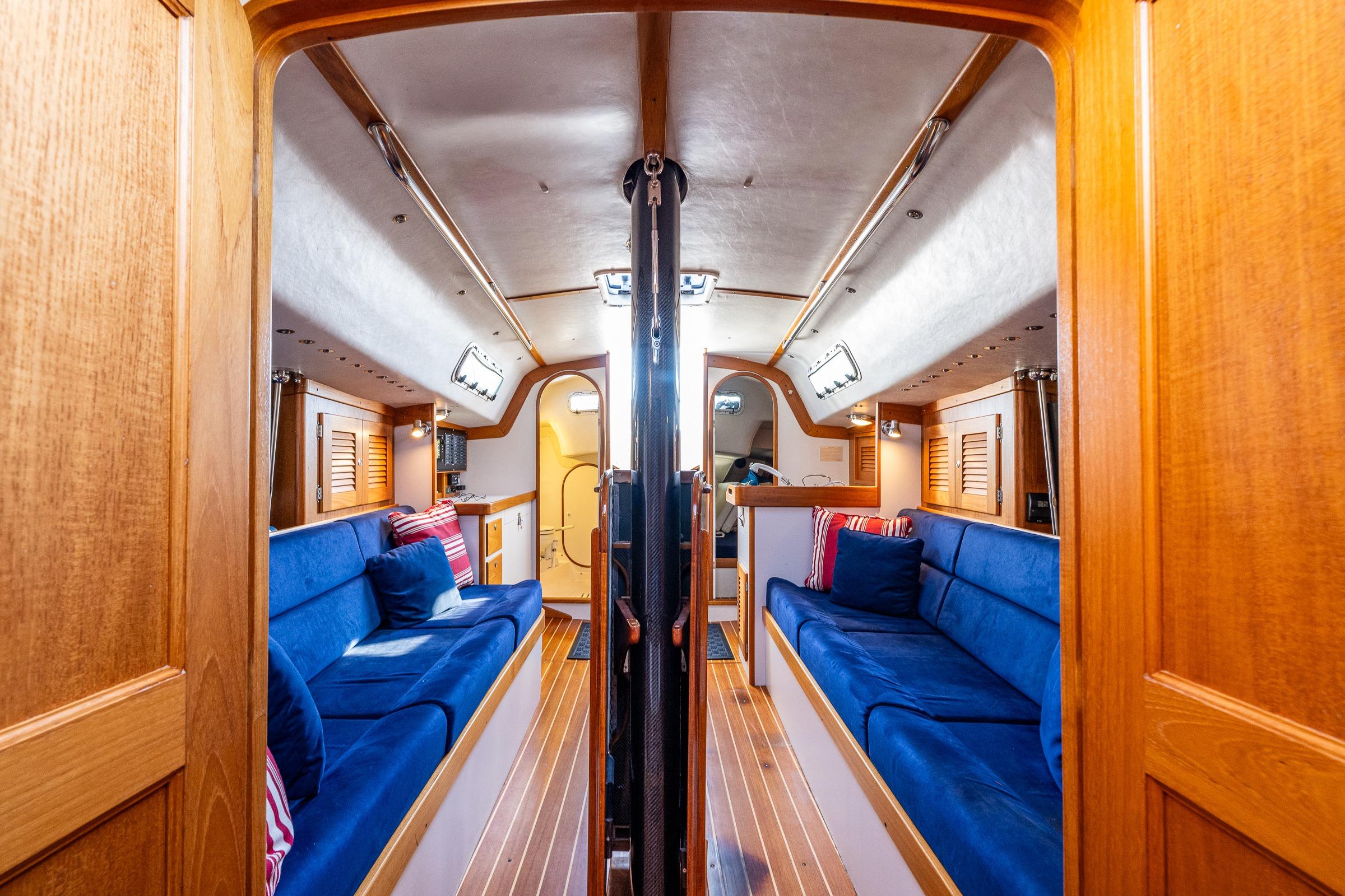 Luxurious 2007 J Boats J/124 interior with blue seating and wooden finishes.