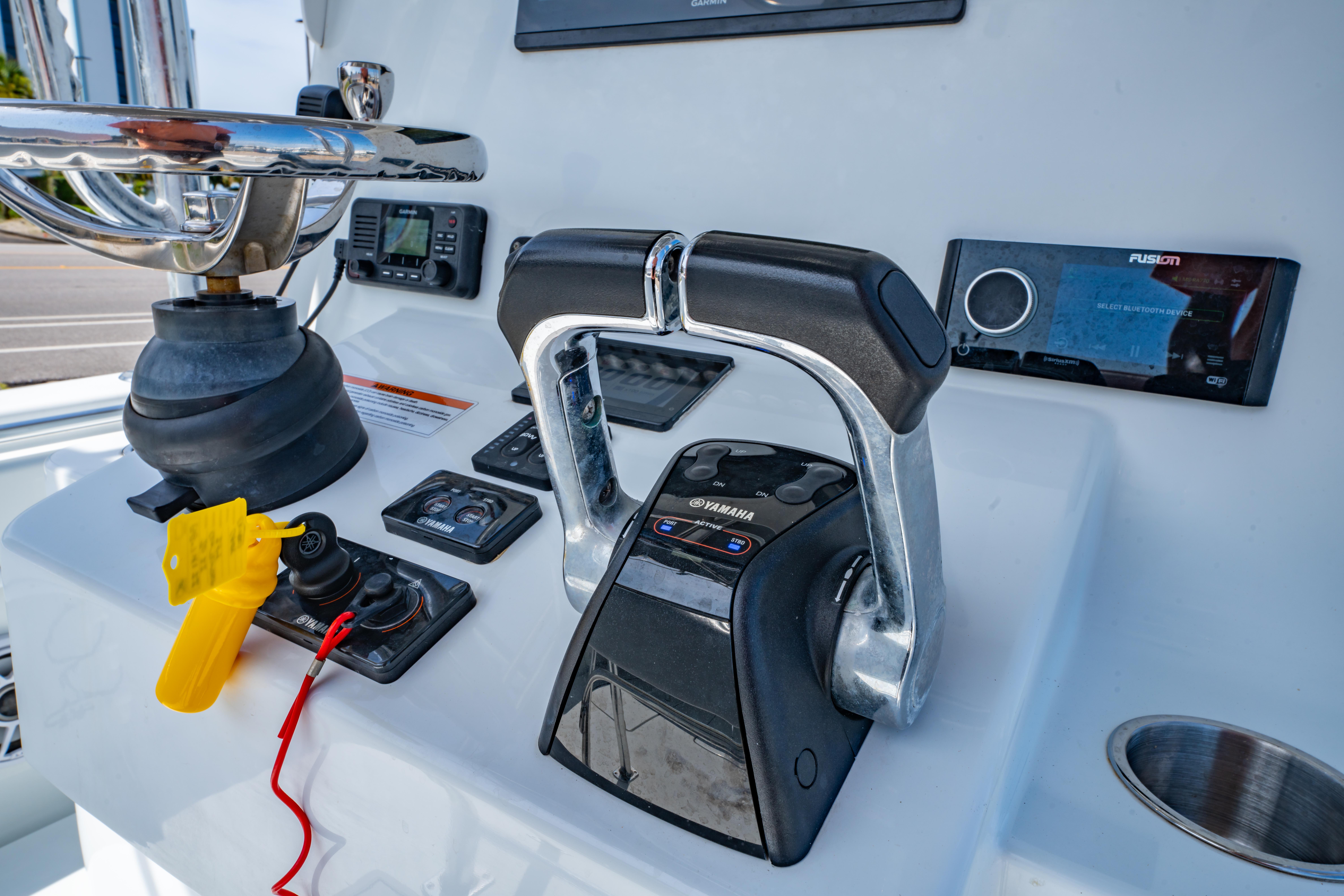 Control panel of 2022 Contender 25T boat with Yamaha throttle and Fusion stereo.